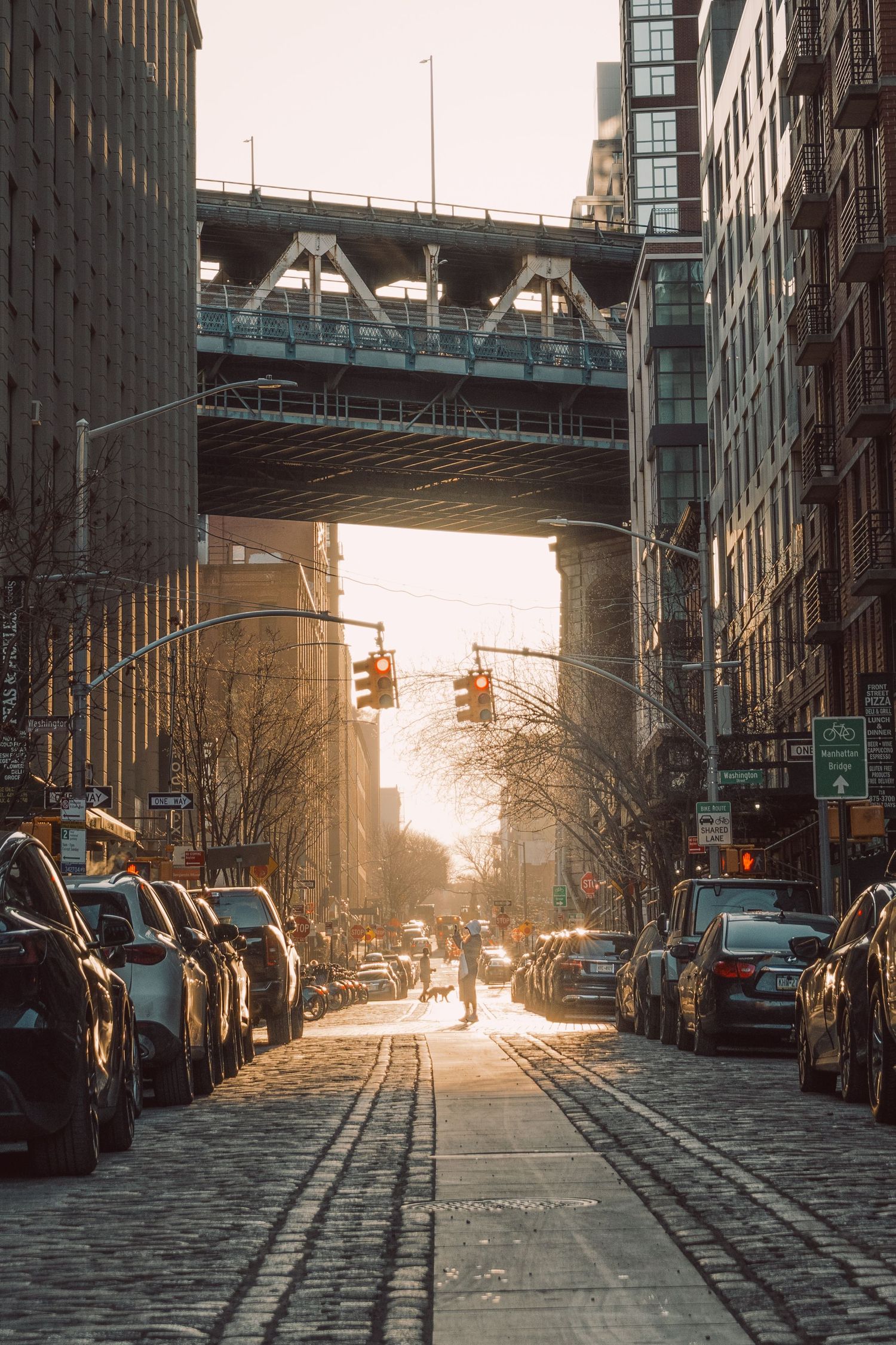 Lower Manhattan street at golden hour beneath the in New York City