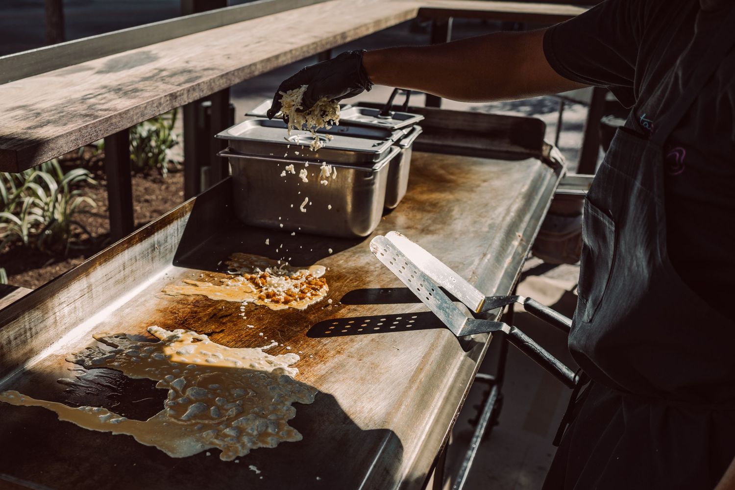 Street tacos cooking on a flat-top griddle at an outdoor food stand in Austin, Texas