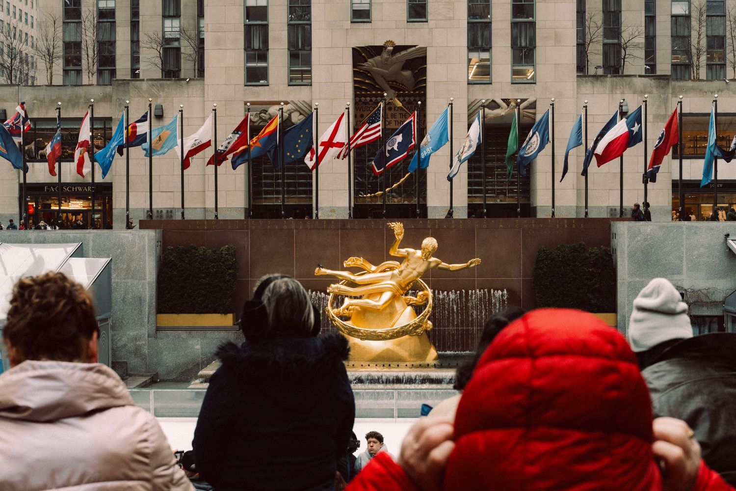 Visitors viewing the Prometheus sculpture at Rockefeller Center in Manhattan, New York City