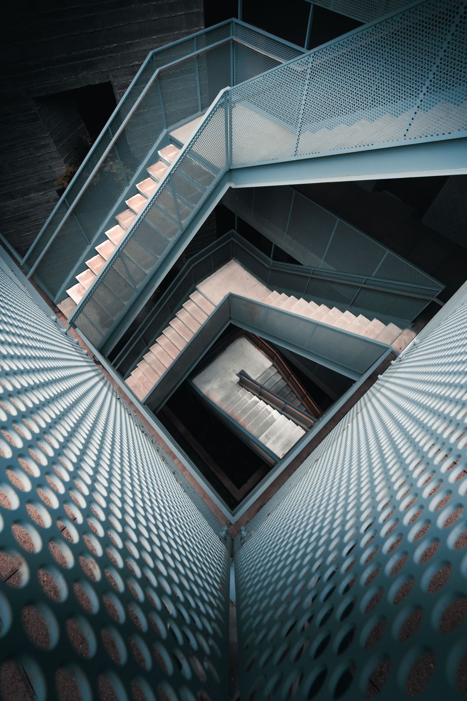 Looking down through repeating geometric staircases at the Chioco Design building in East Austin, Texas