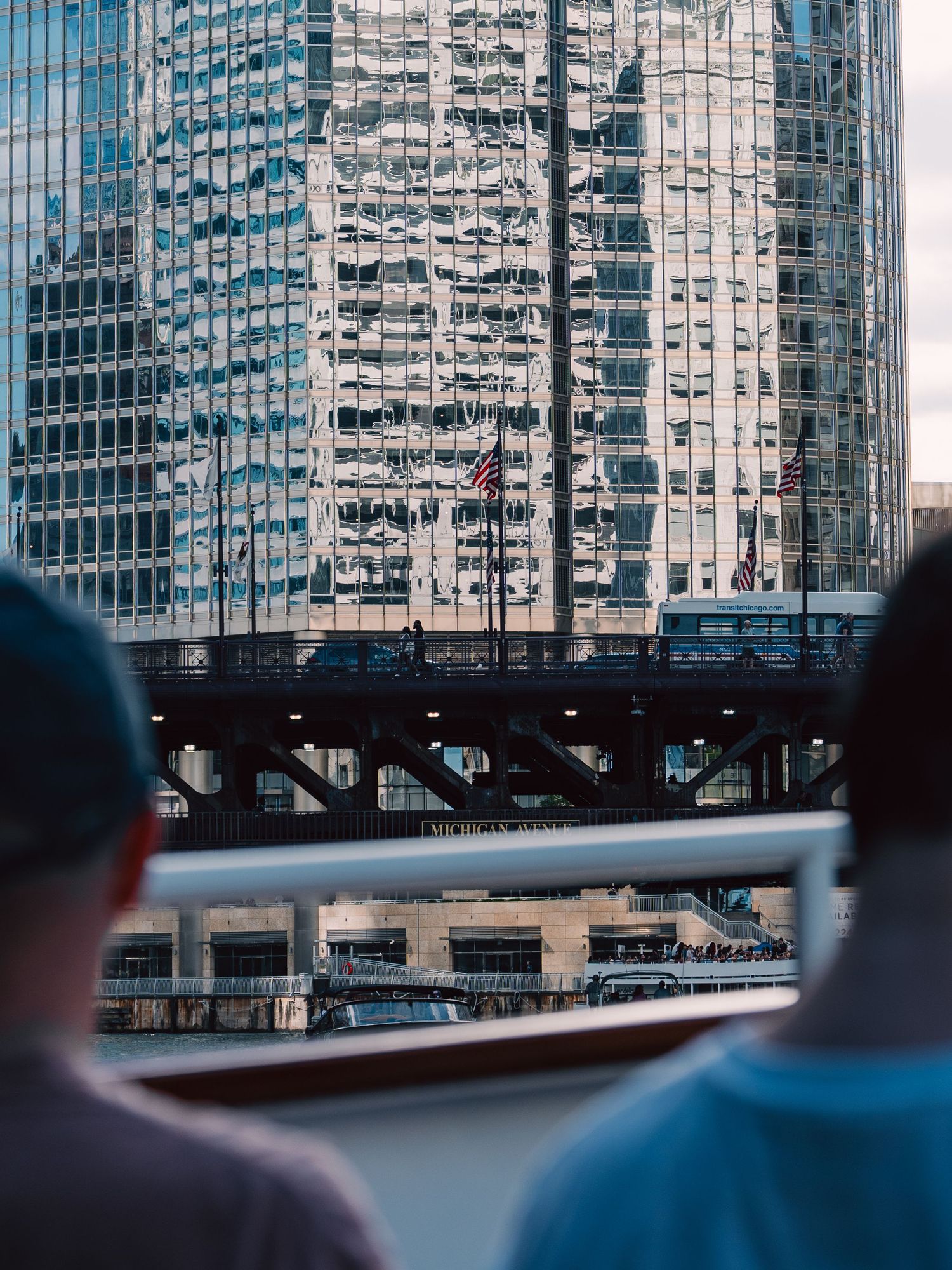 Passengers looking toward Chicago architecture from a boat on the Chicago River