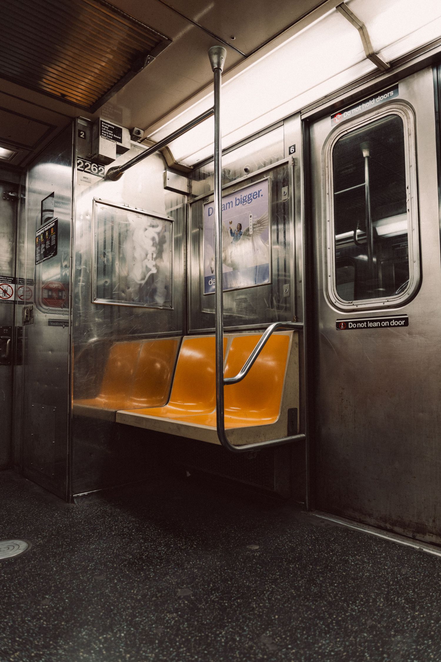 Empty orange seats inside a New York City subway car
