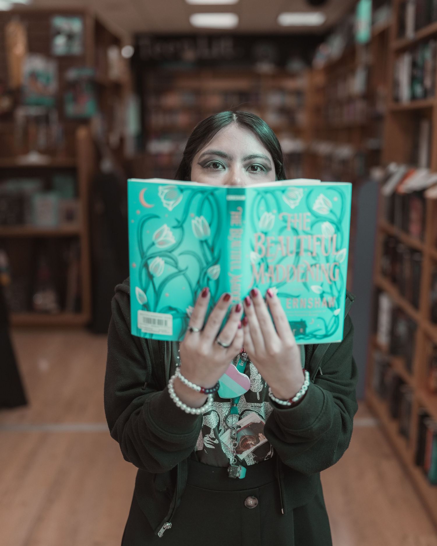 BookPeople customer holding an open book inside the Austin bookstore