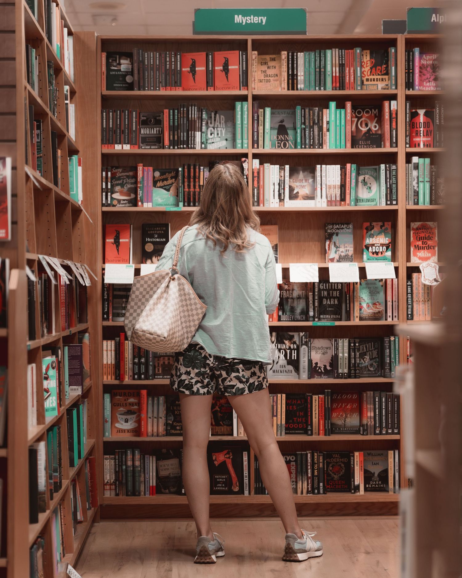Customer browsing the mystery section at BookPeople in Austin, Texas