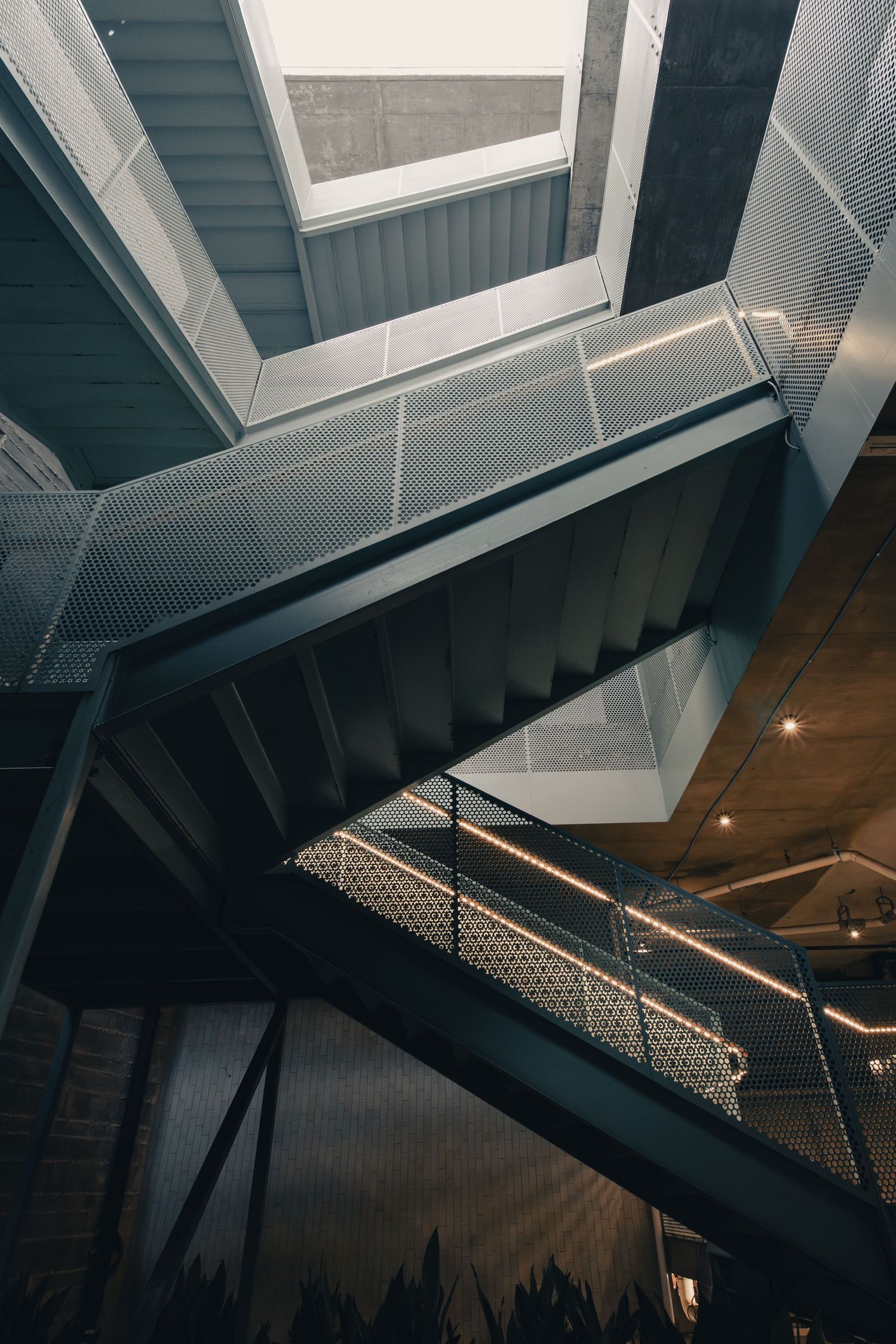 Abstract view through intersecting staircases at the Chioco Design building in East Austin, Texas