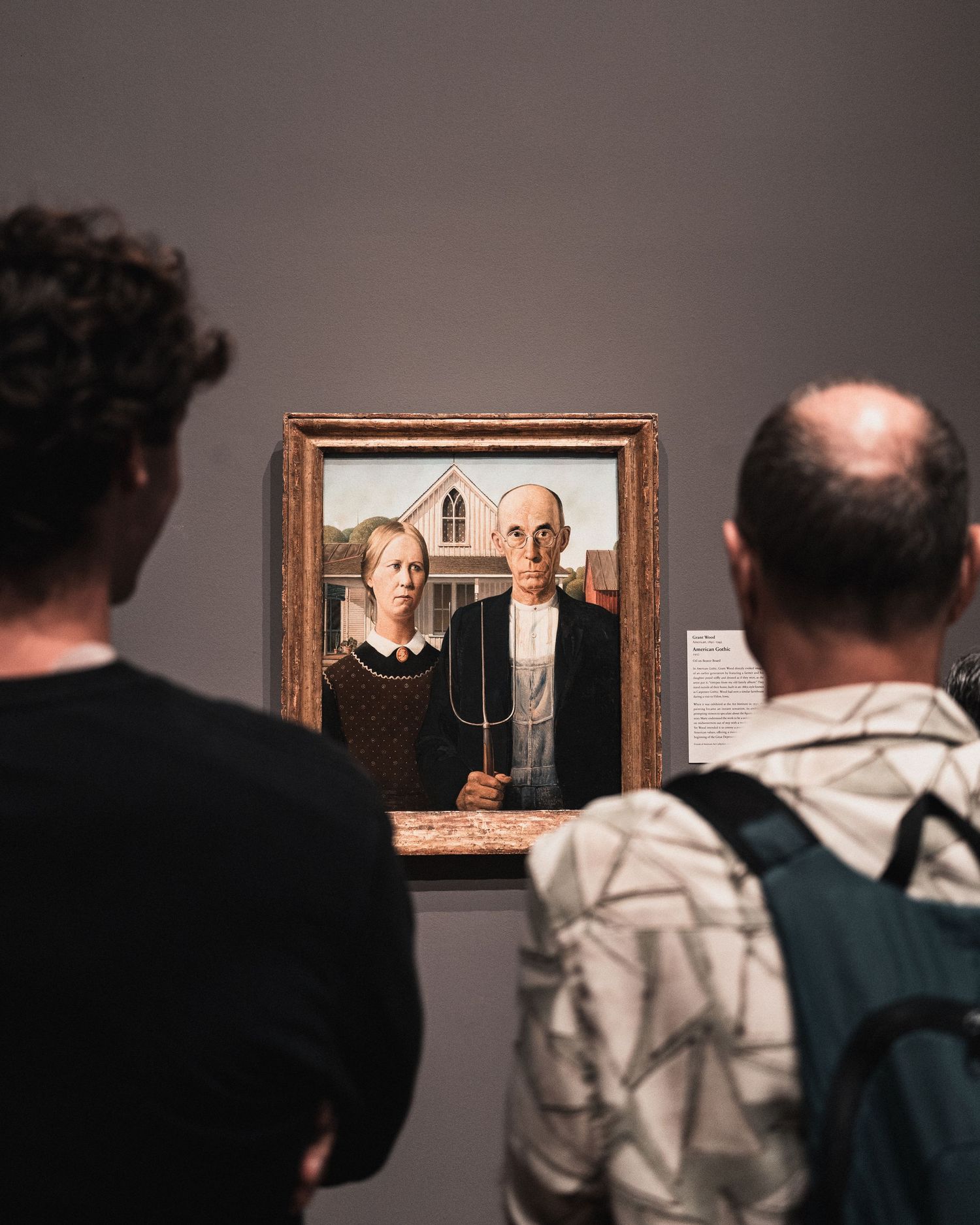 Visitors viewing Grant Wood’s American Gothic at the Art Institute of Chicago
