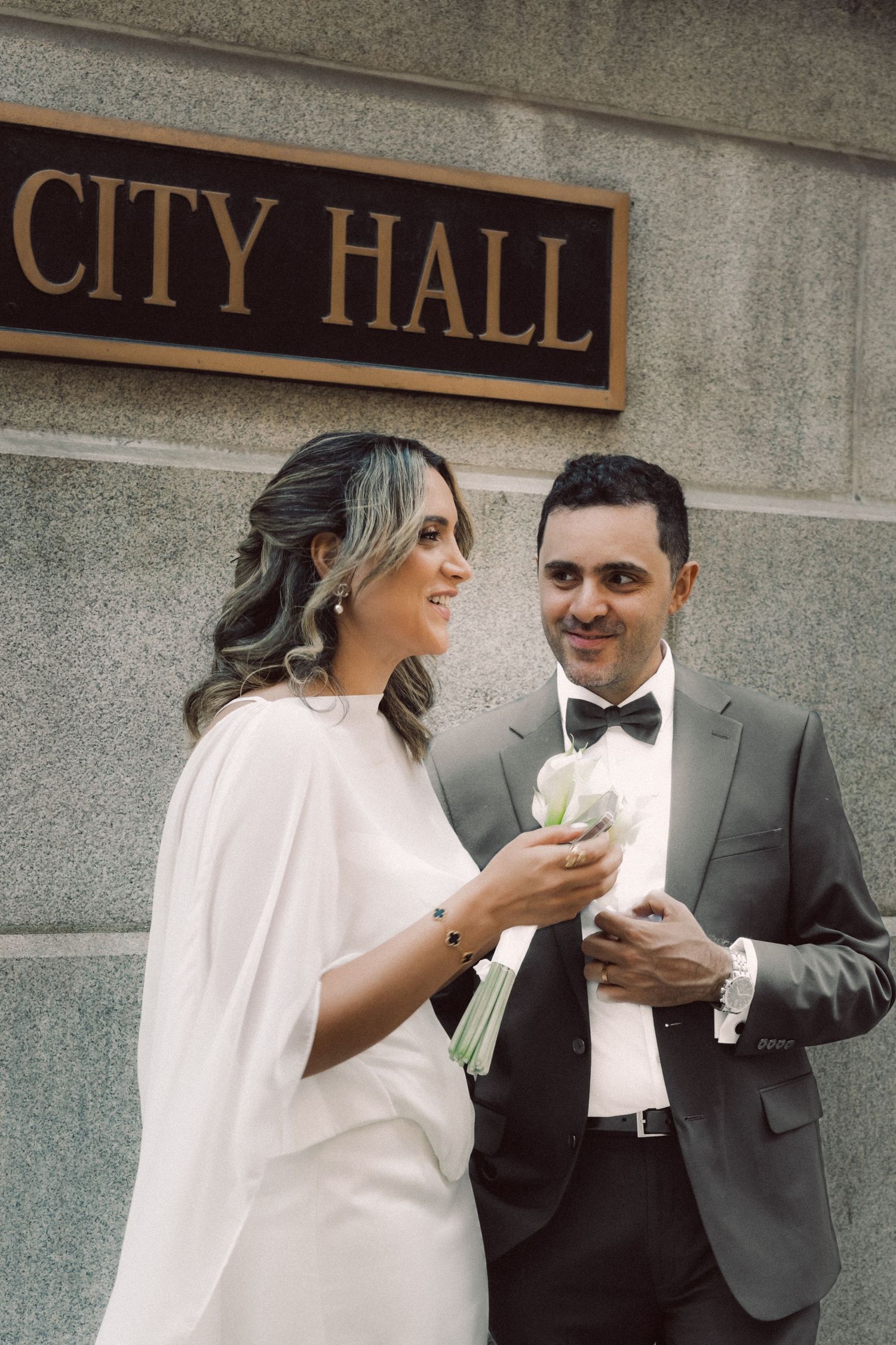 Candid street photograph of a recently married couple outside City Hall in downtown Chicago
