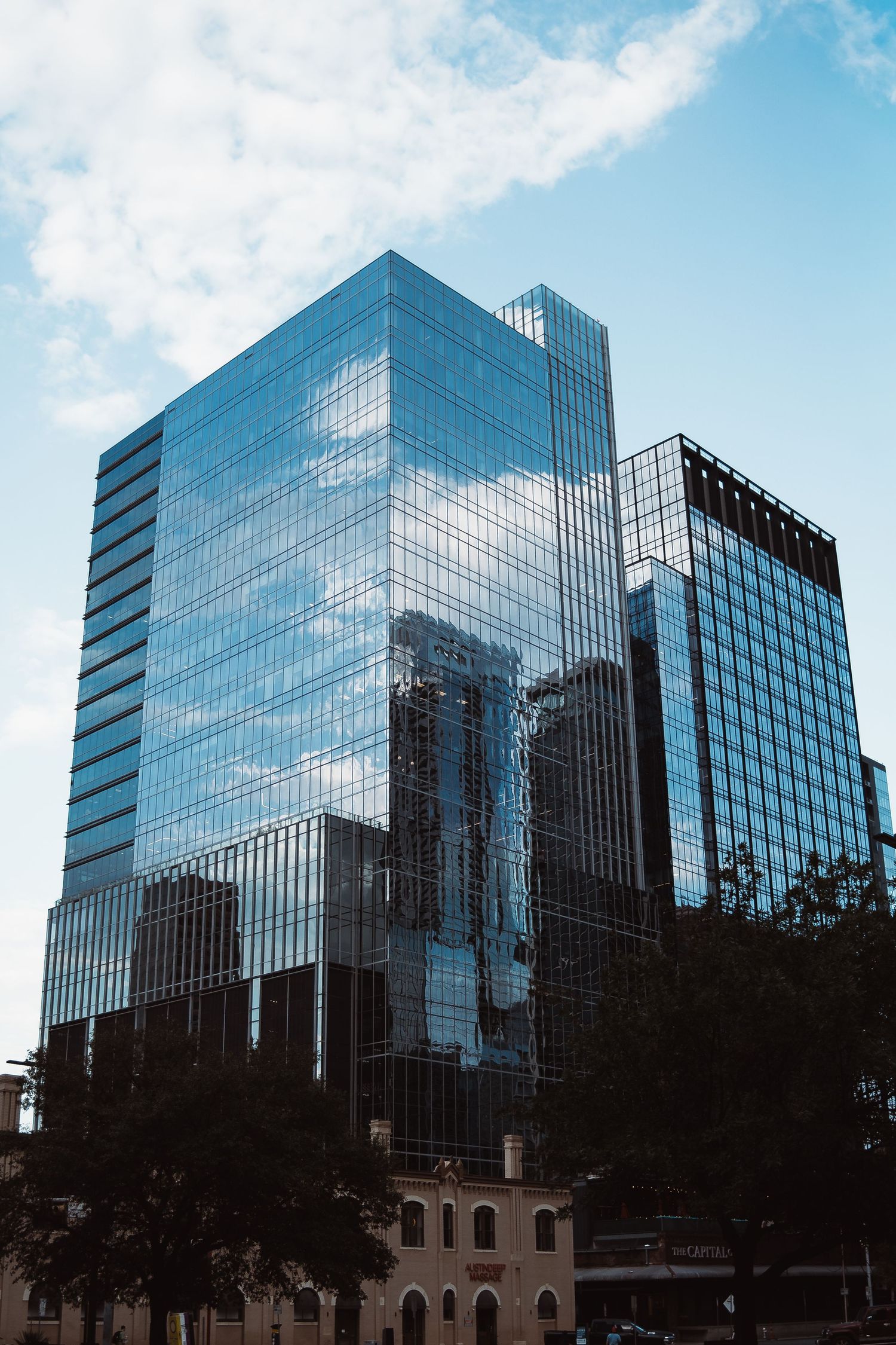 Glass office tower reflecting the downtown Austin skyline