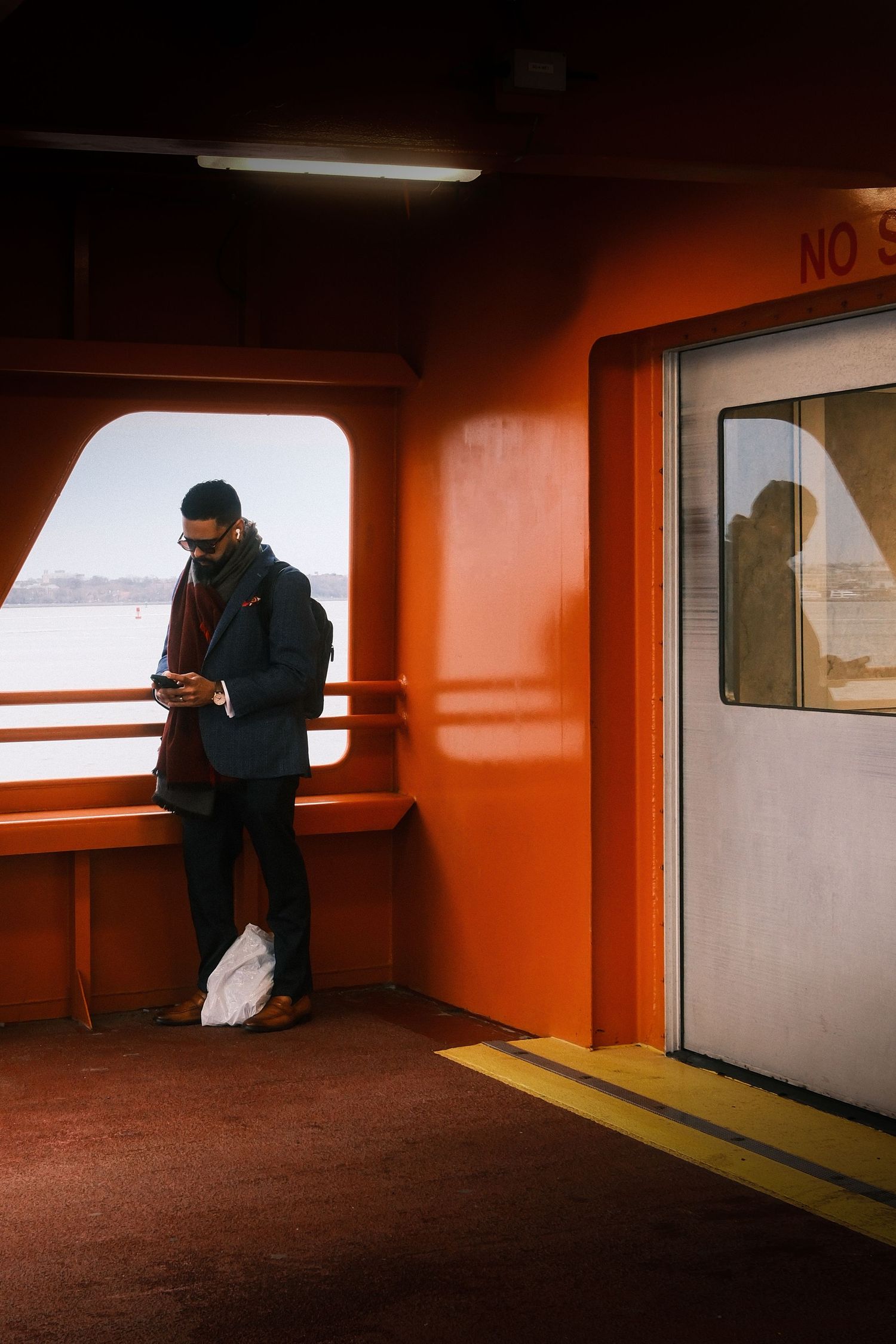 Candid passenger standing inside the Staten Island Ferry in New York City