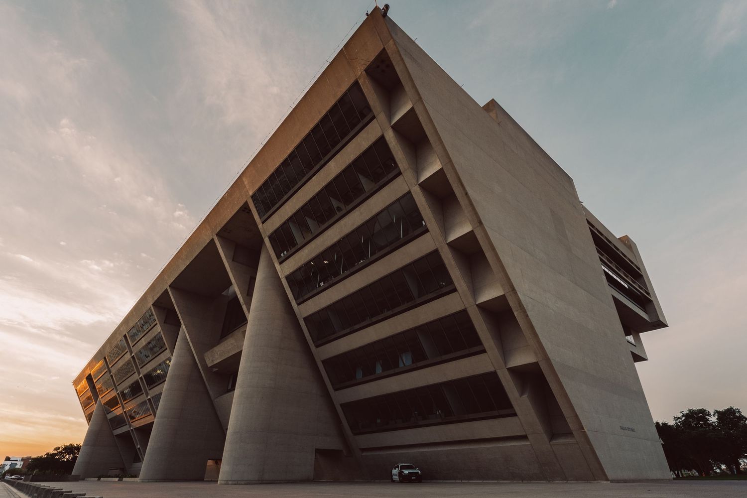 Wide-angle architectural view of the Brutalist facade of Dallas City Hall in Dallas, Texas