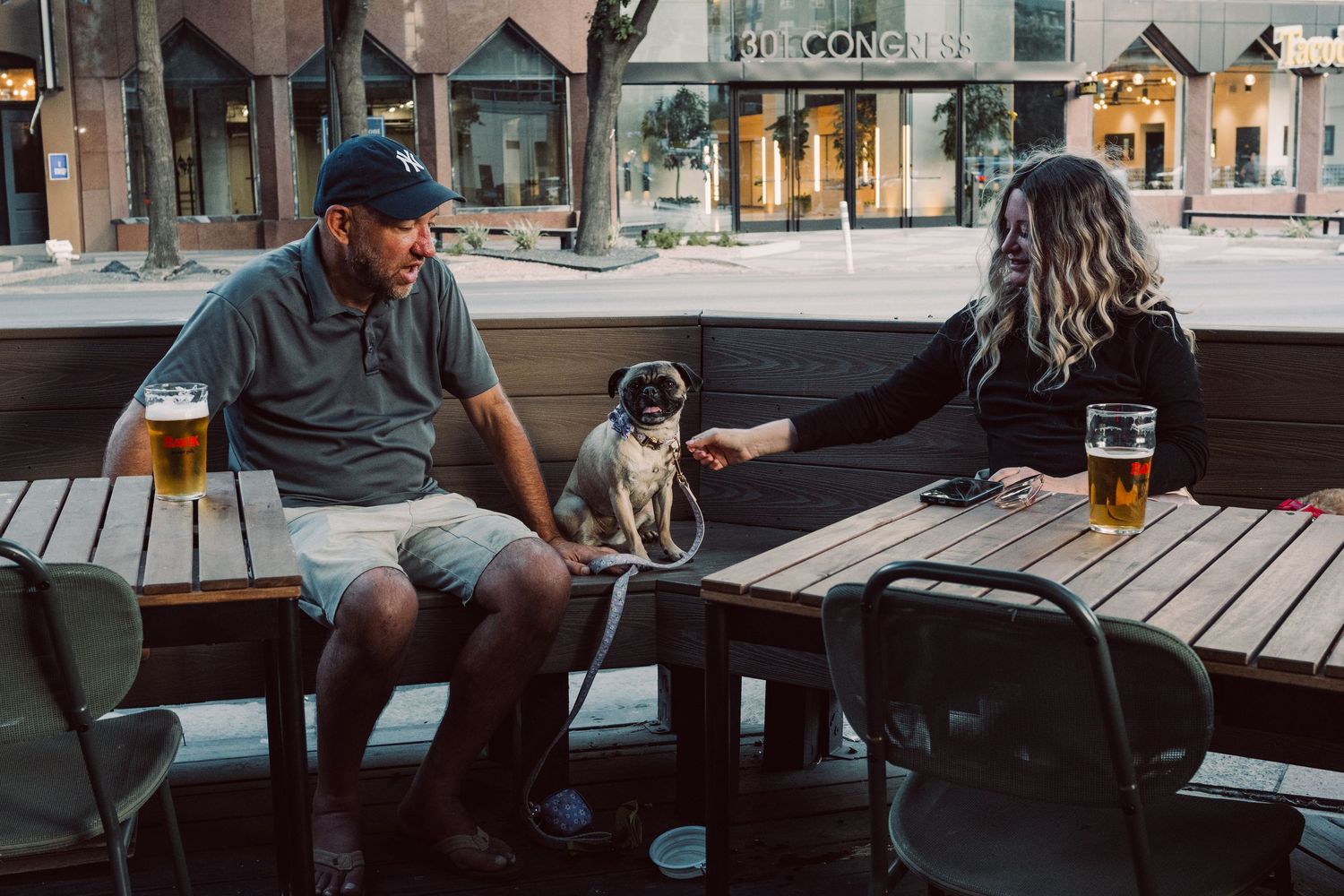 Candid scene of people relaxing with their dog in downtown Austin, Texas