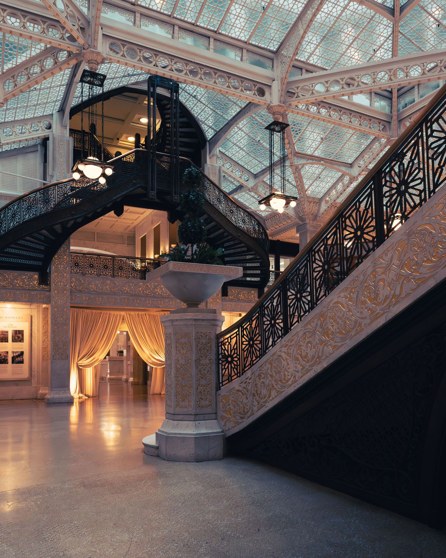 Ornate staircase and glass atrium inside the historic Rookery Building in Chicago