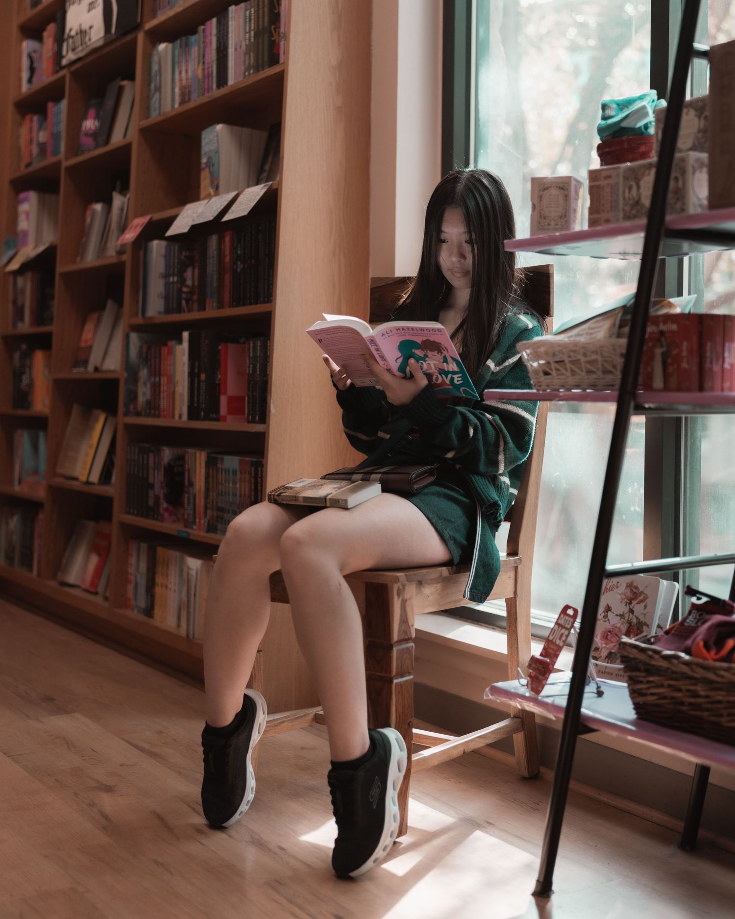 Customer reading beside the bookshelves at BookPeople in Austin, Texas