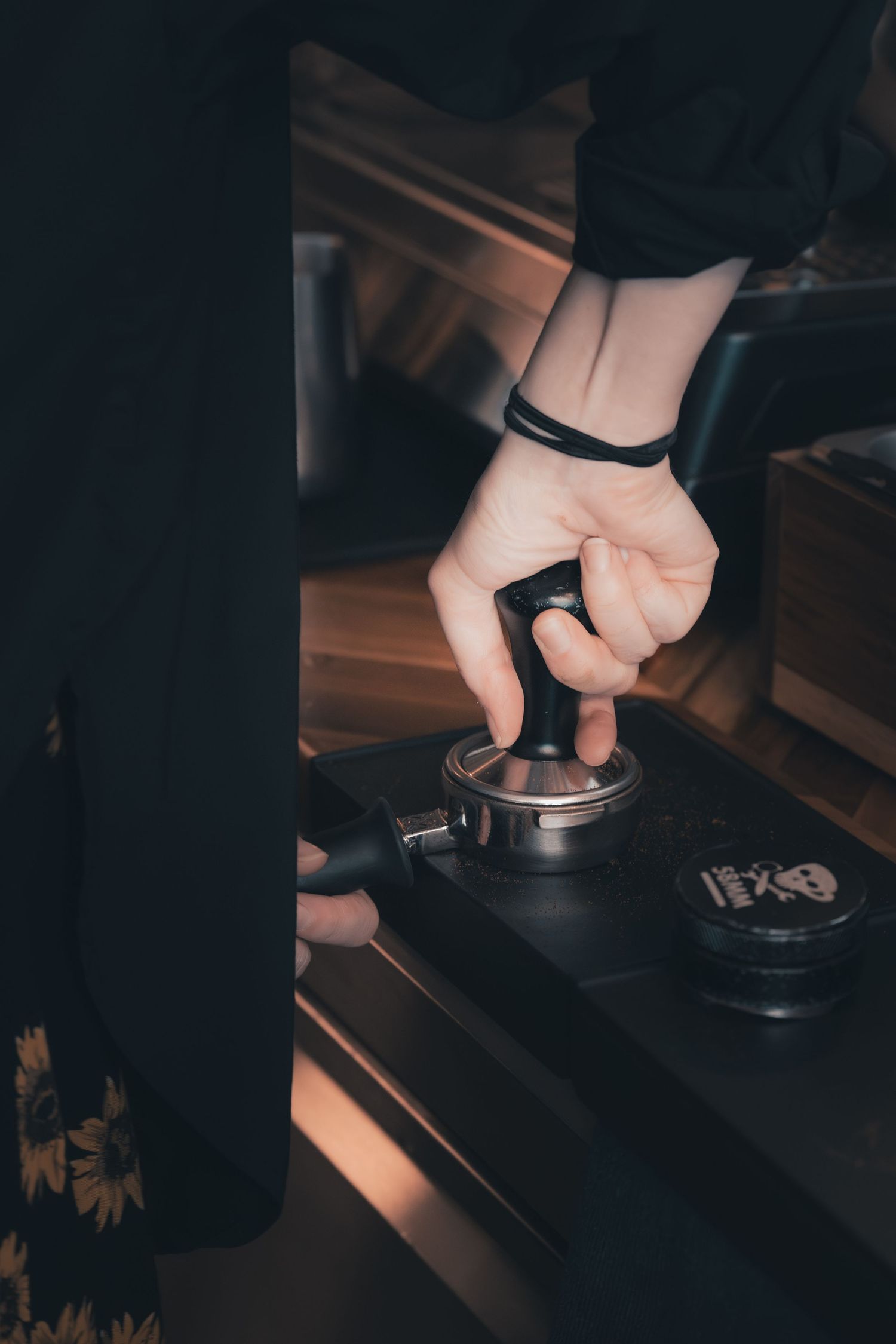 Barista tamping espresso at Klerje Coffee in East Austin