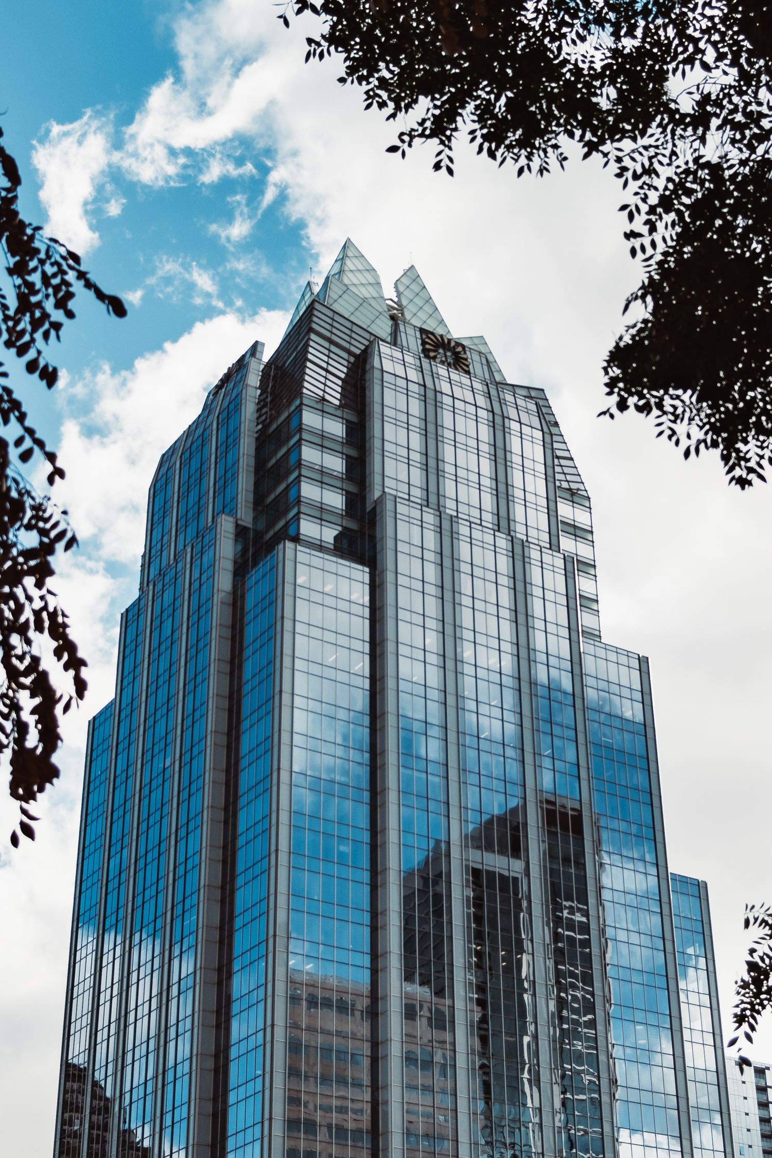 Modern glass skyscraper photographed from street level in downtown Austin