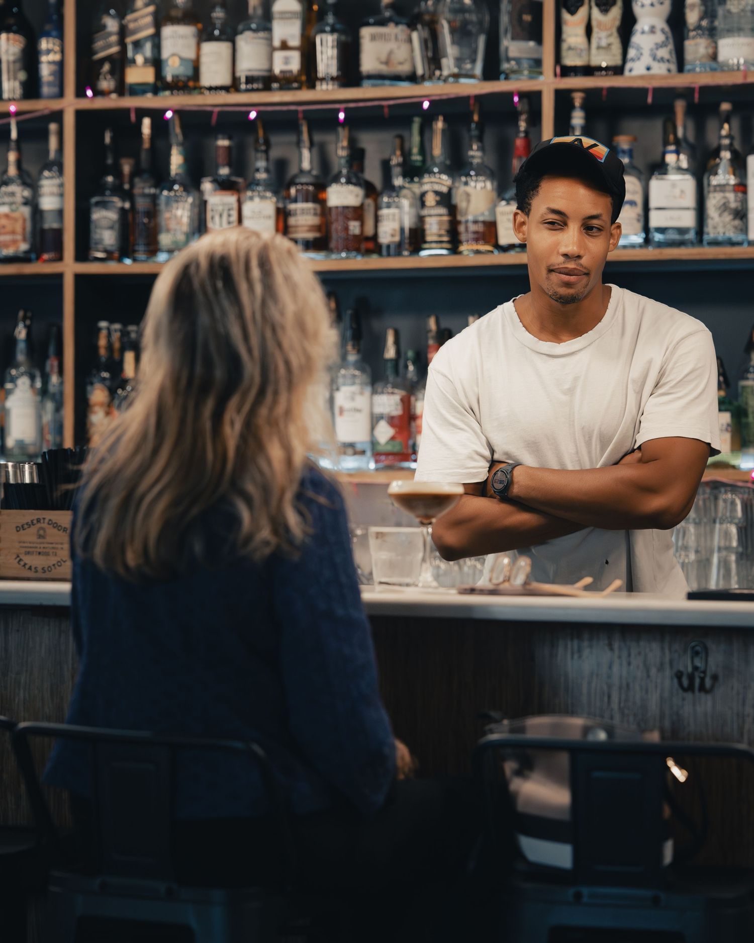 Bartender serving a customer at Halcyon Coffee, Bar & Lounge in Austin, Texas