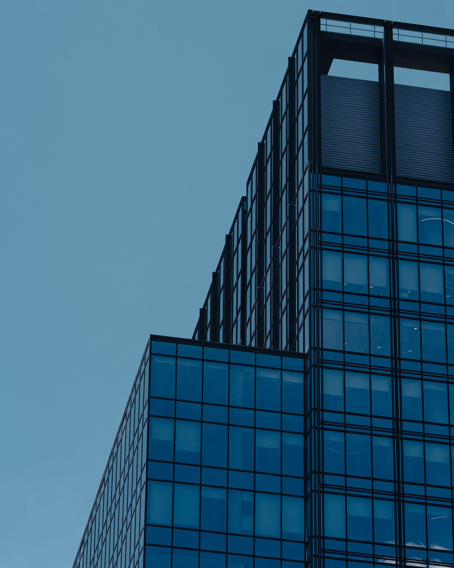Geometric glass high-rise architecture against a blue sky in downtown Austin, Texas