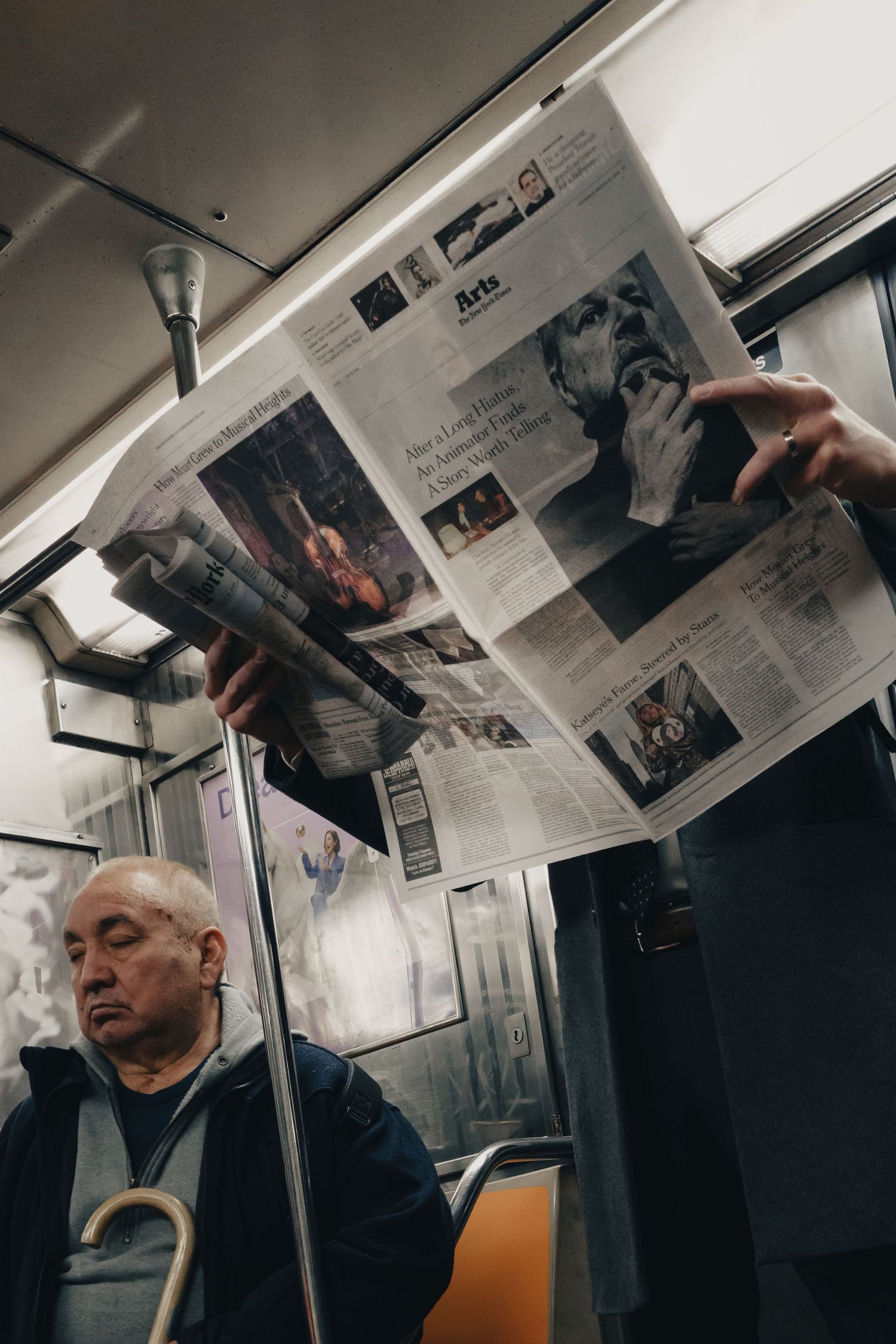 Passenger reading a newspaper on the New York City subway