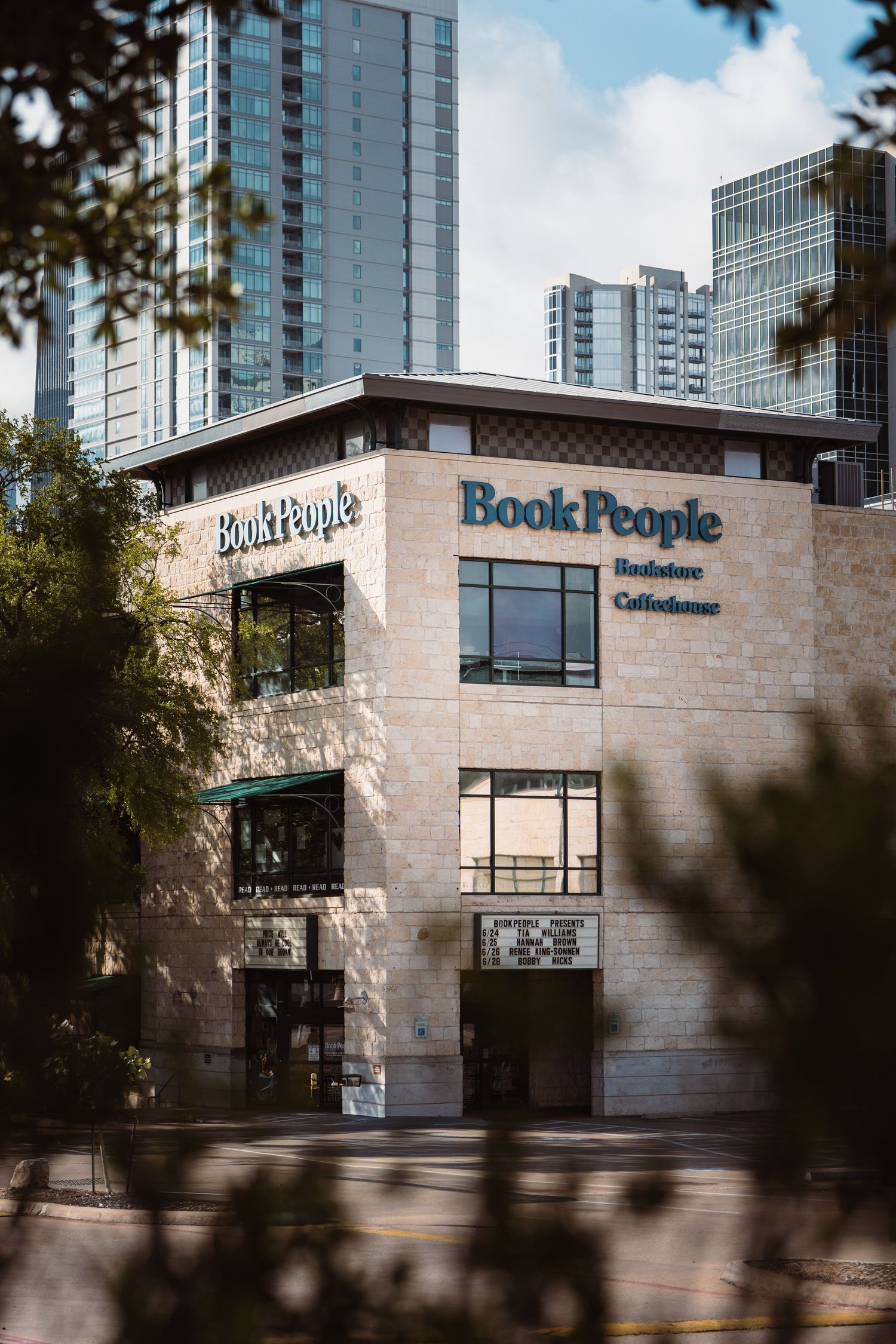 BookPeople bookstore framed by trees and downtown architecture in Austin, Texas