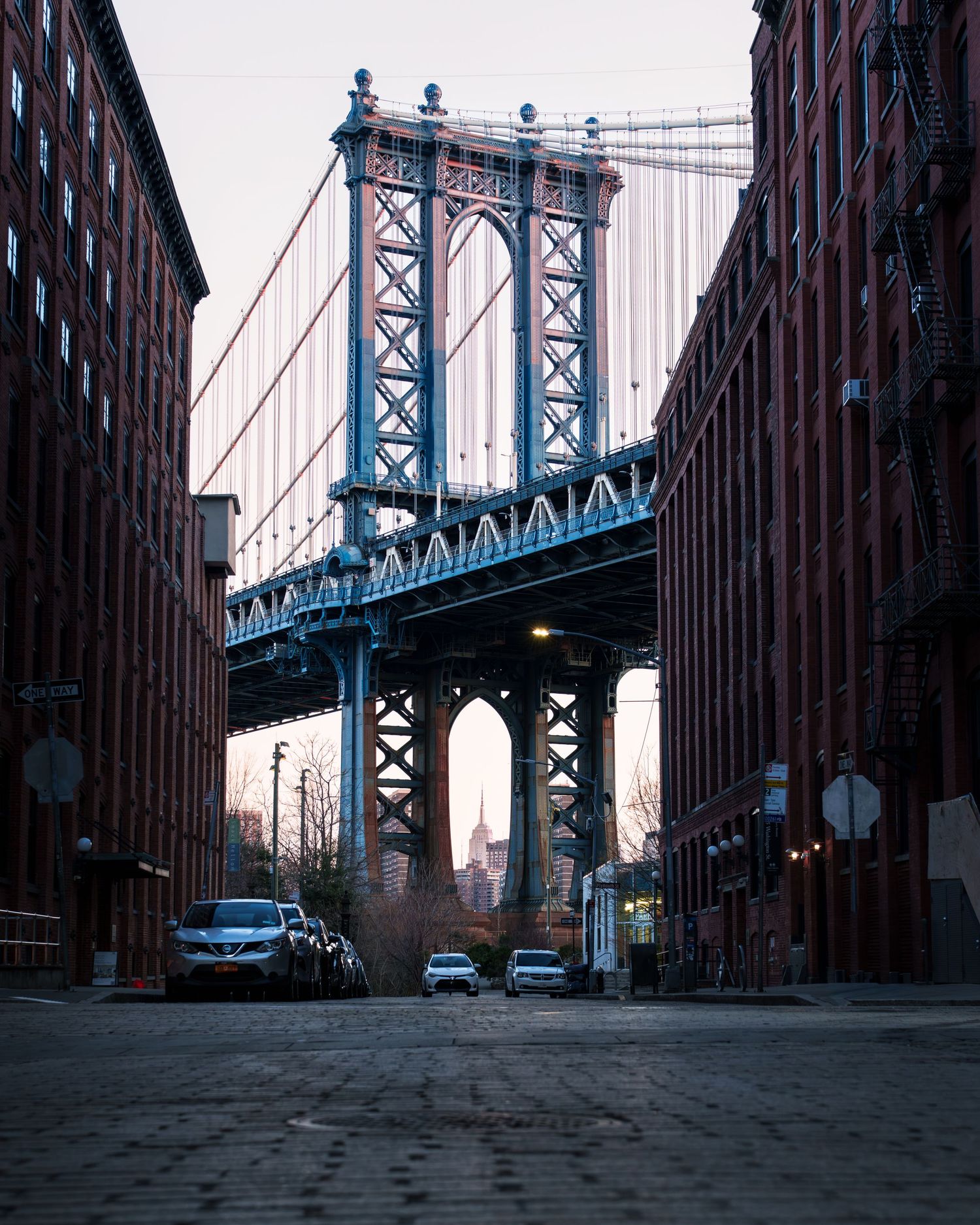 Manhattan Bridge framed by brick buildings in DUMBO, Brooklyn, New York City