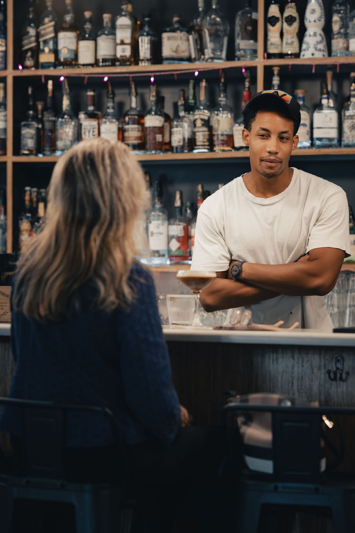 Bartender serving a customer at Halcyon Coffee, Bar & Lounge in downtown Austin