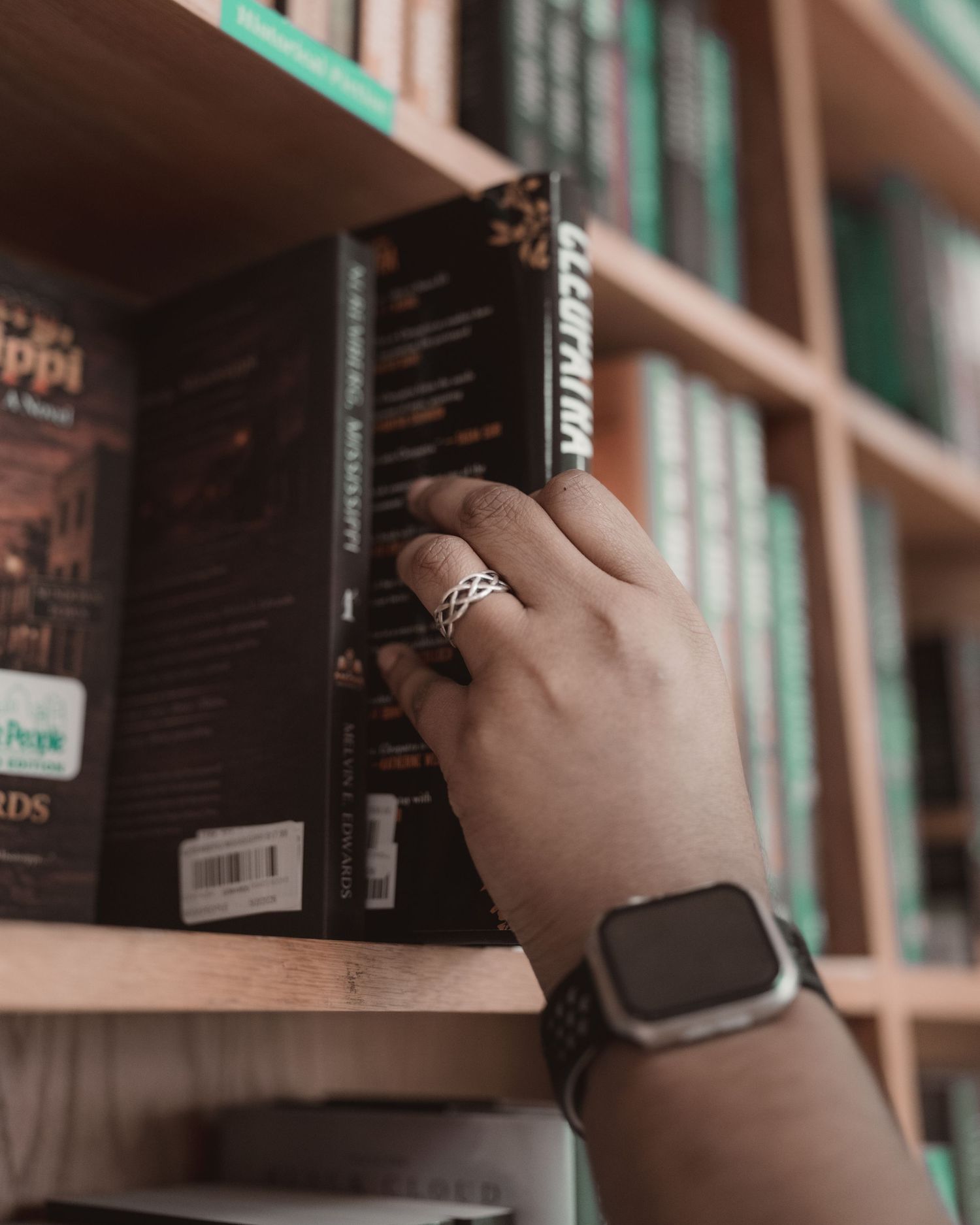 Customer selecting a book from the shelves at BookPeople in Austin, Texas