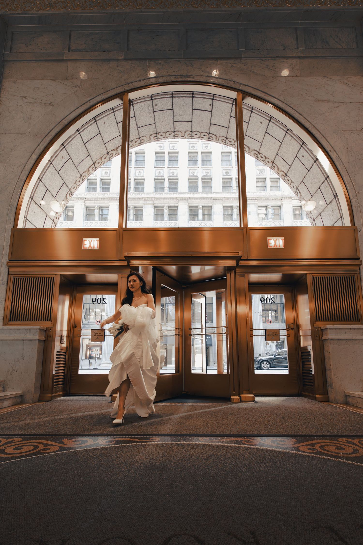 Bride entering an arched entrance inside the historic Rookery Building in Chicago