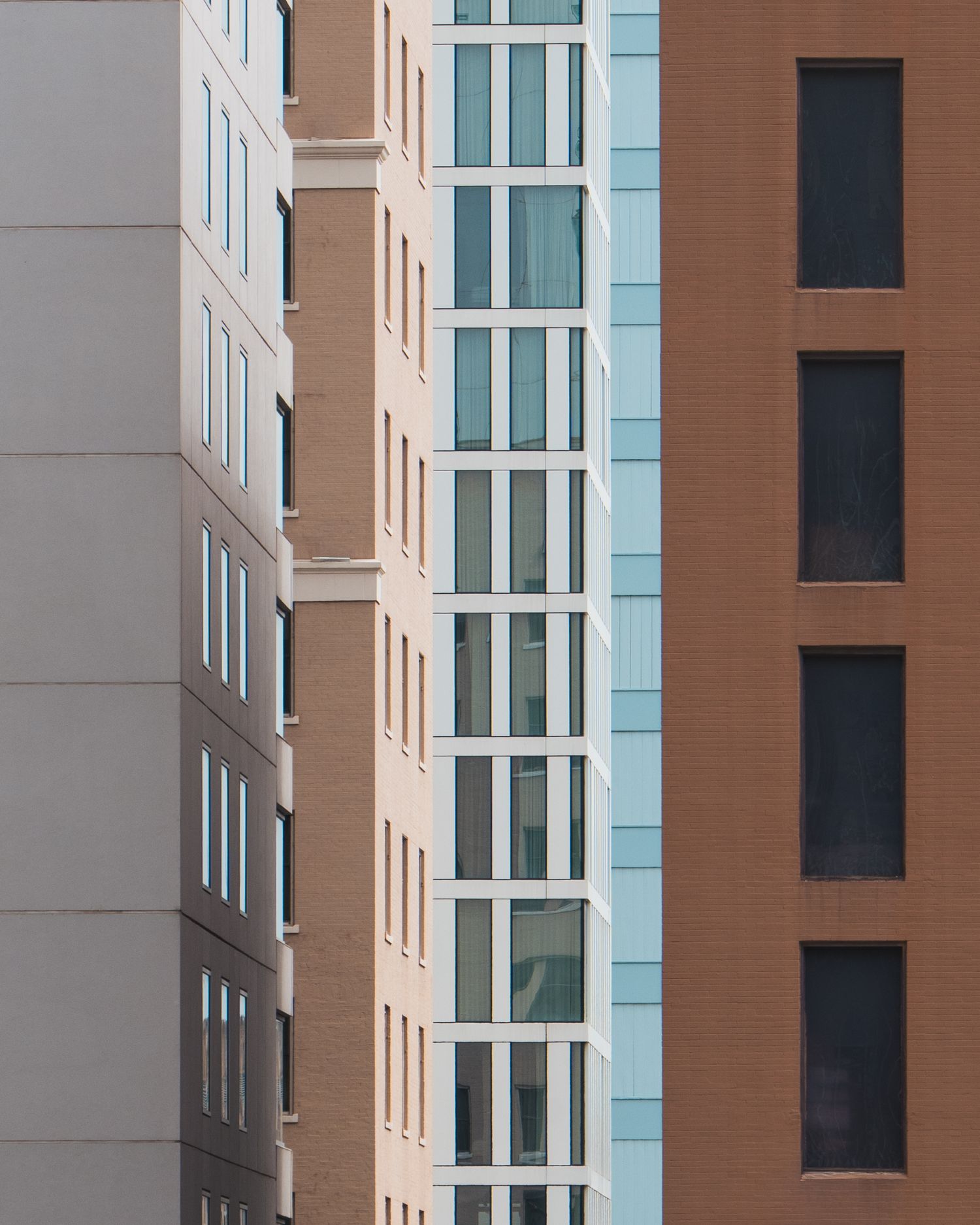 Layered facades of modern urban buildings in contrasting colors and textures downtown Austin