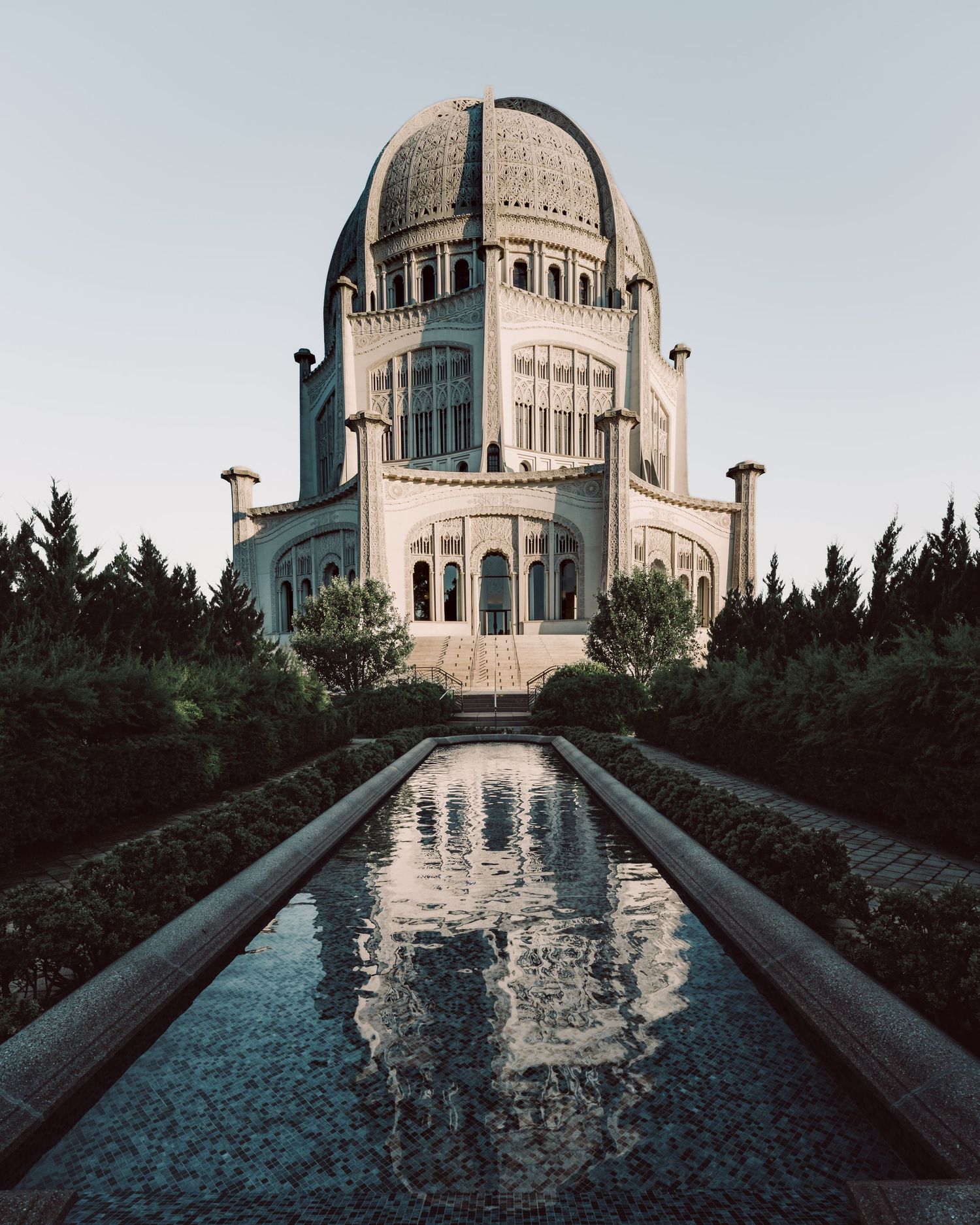 Baha'i House of Worship reflected in a long pool at dusk