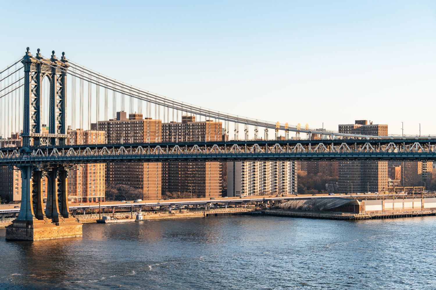 Manhattan Bridge and East River viewed from the Brooklyn Bridge in New York City