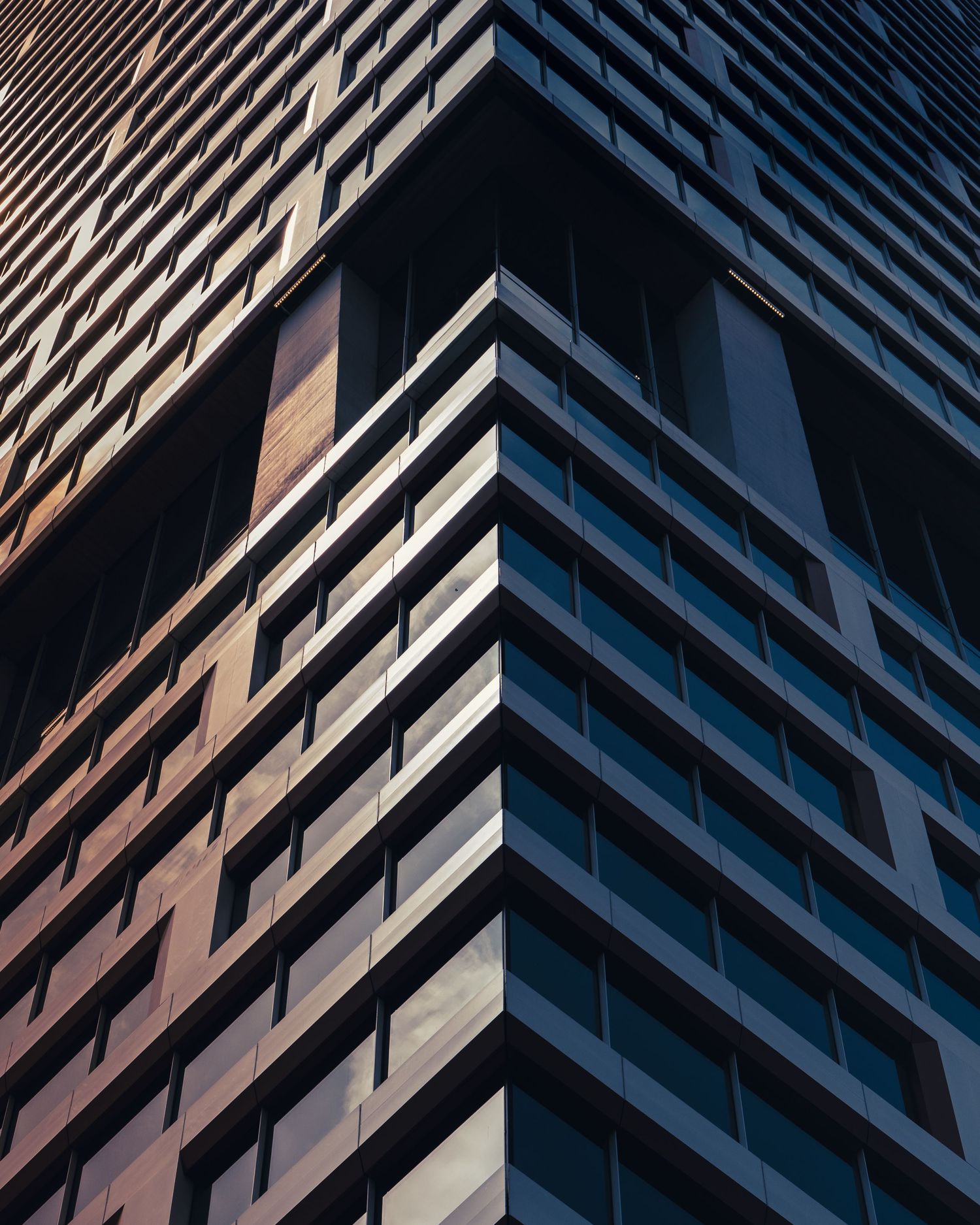 Architectural detail of the Waterline tower rising above downtown Austin, Texas