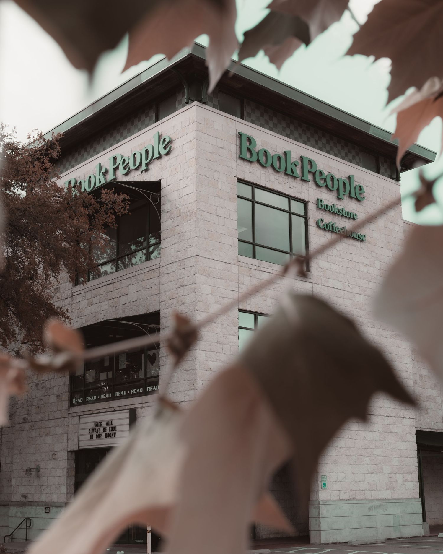 BookPeople bookstore framed by foreground leaves in downtown Austin, Texas