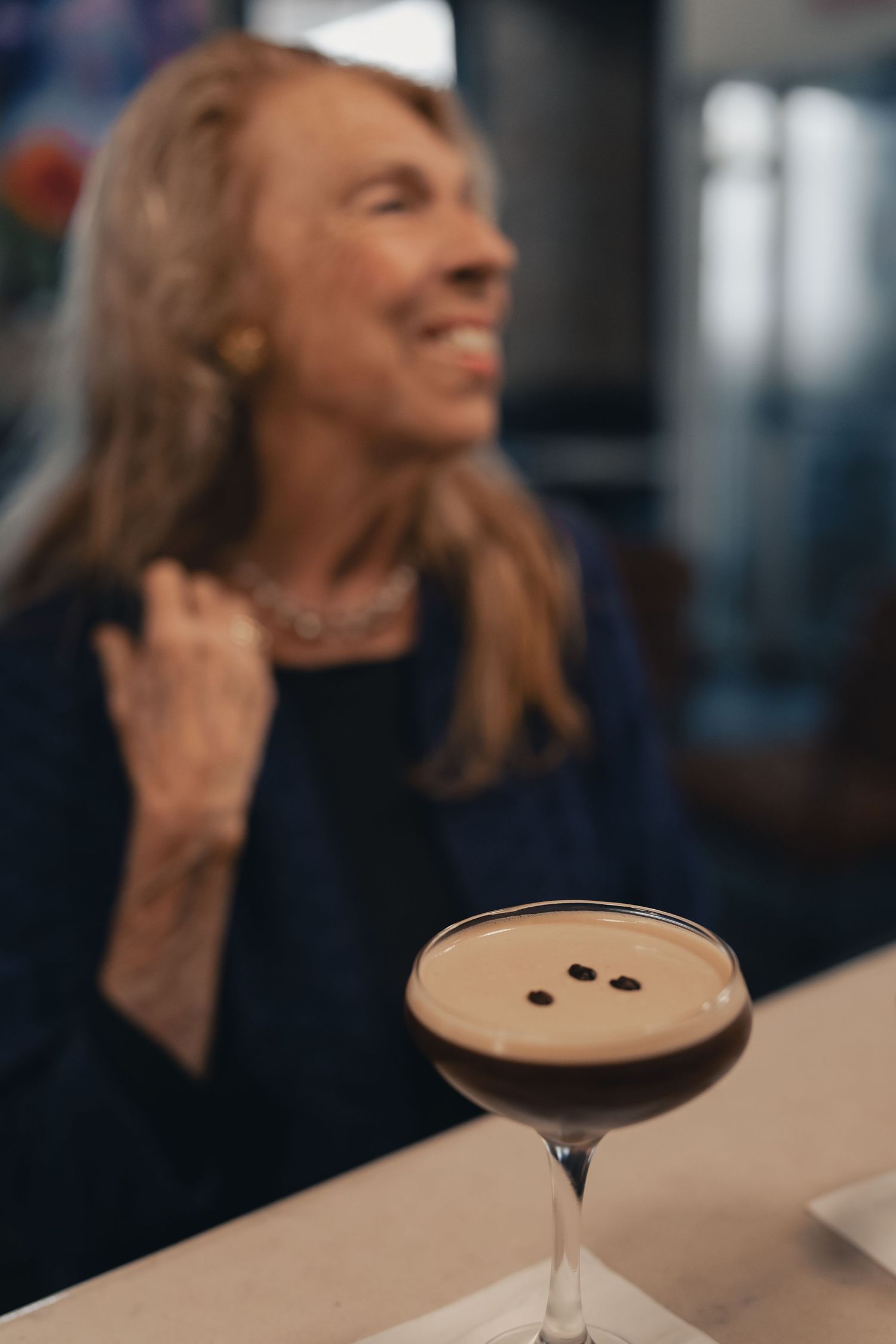 Customer enjoying an espresso martini at Halcyon Coffee, Bar & Lounge in downtown Austin