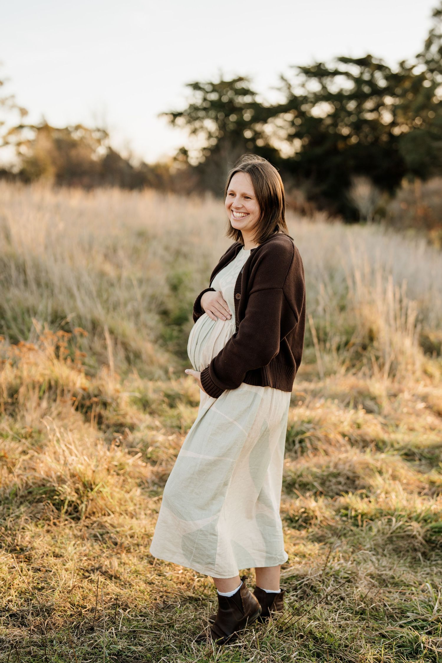Pregnant woman outdoors in golden evening light during a Christchurch maternity photography session