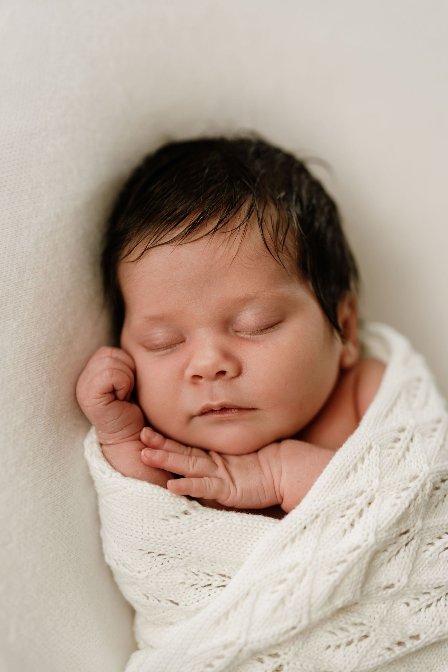 Close-up portrait of a sleeping newborn baby during an in-home newborn photography session in Christchurch