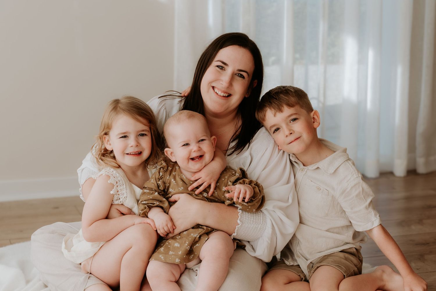 Katie with her three children during a relaxed studio family photography session in Christchurch