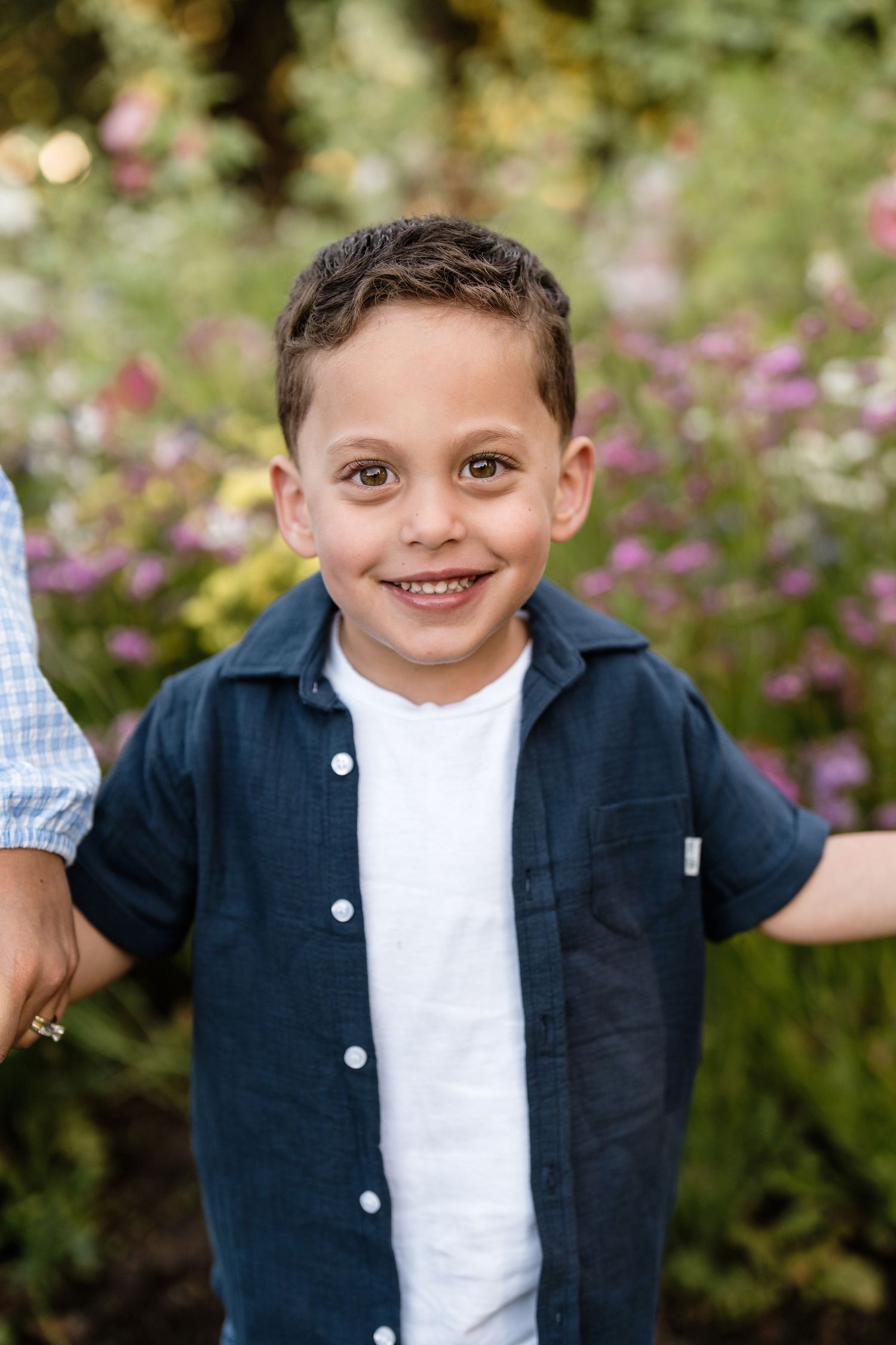 Smiling young boy outdoors during a relaxed family photography session in Christchurch