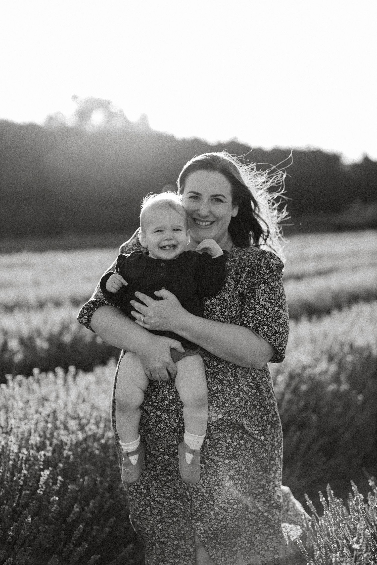 Black and white photo of Katie cuddling her young child during a Christchurch family photography session