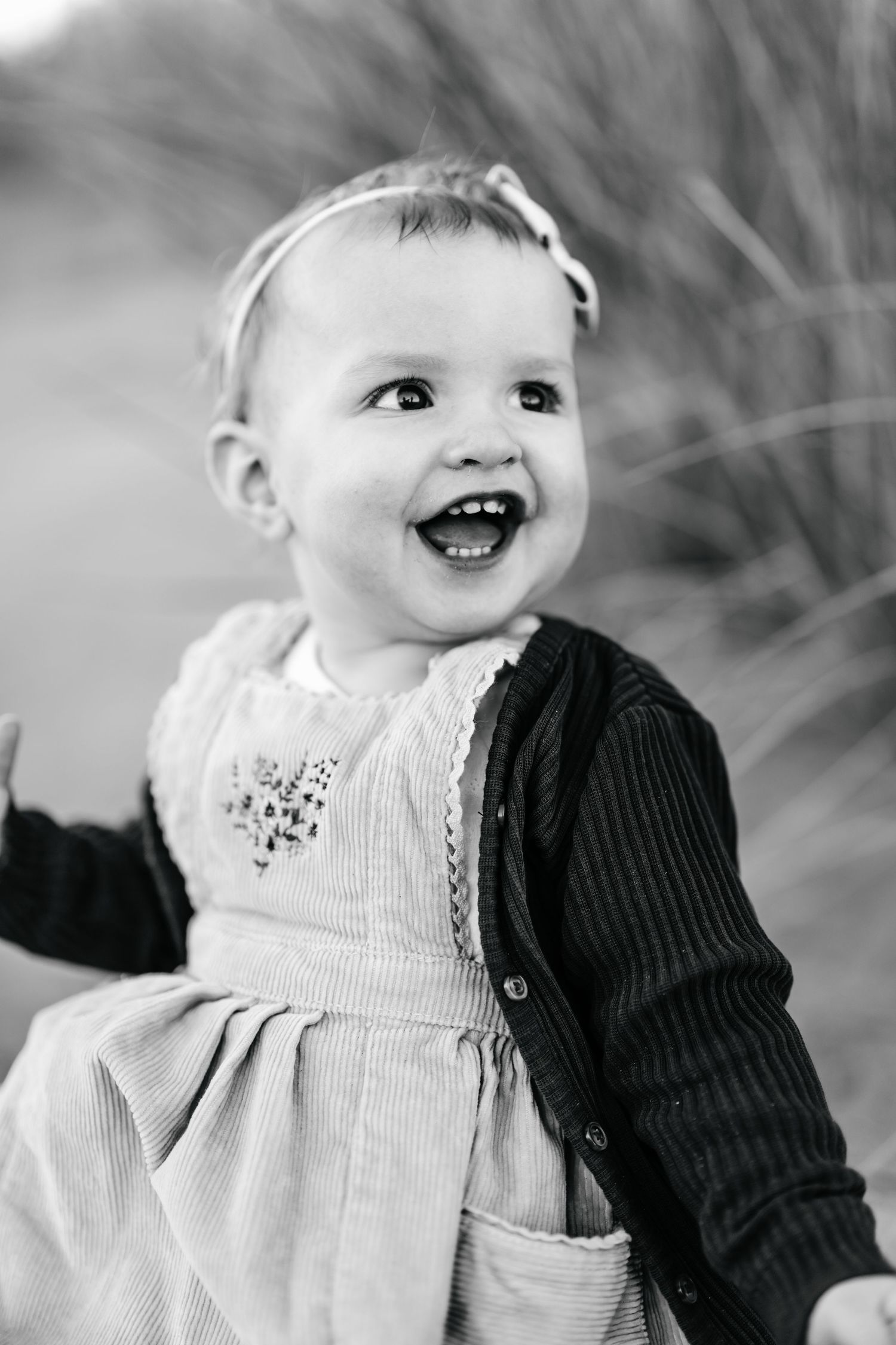 Black and white portrait of a smiling young girl during an outdoor family photography session