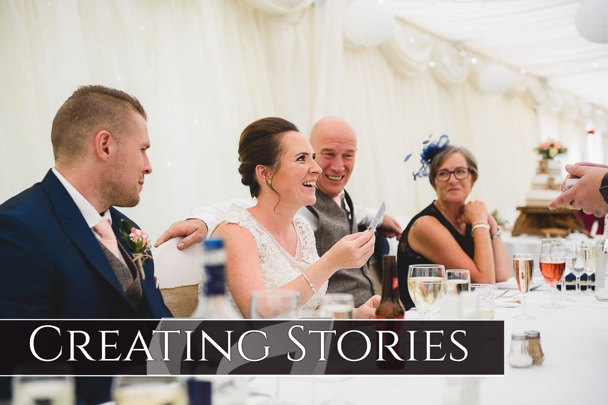 Wedding guests enjoying a magical performance during a reception in an elegant white-draped venue.