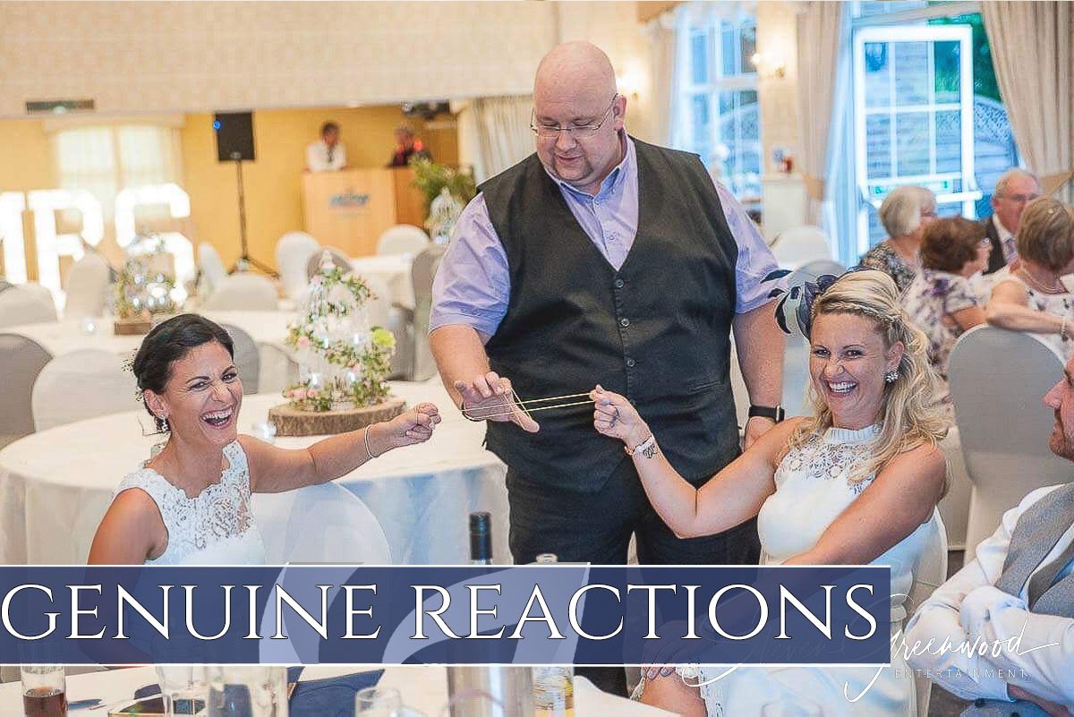 Guests reacting with joy and amazement during an interactive performance at an elegant indoor venue.