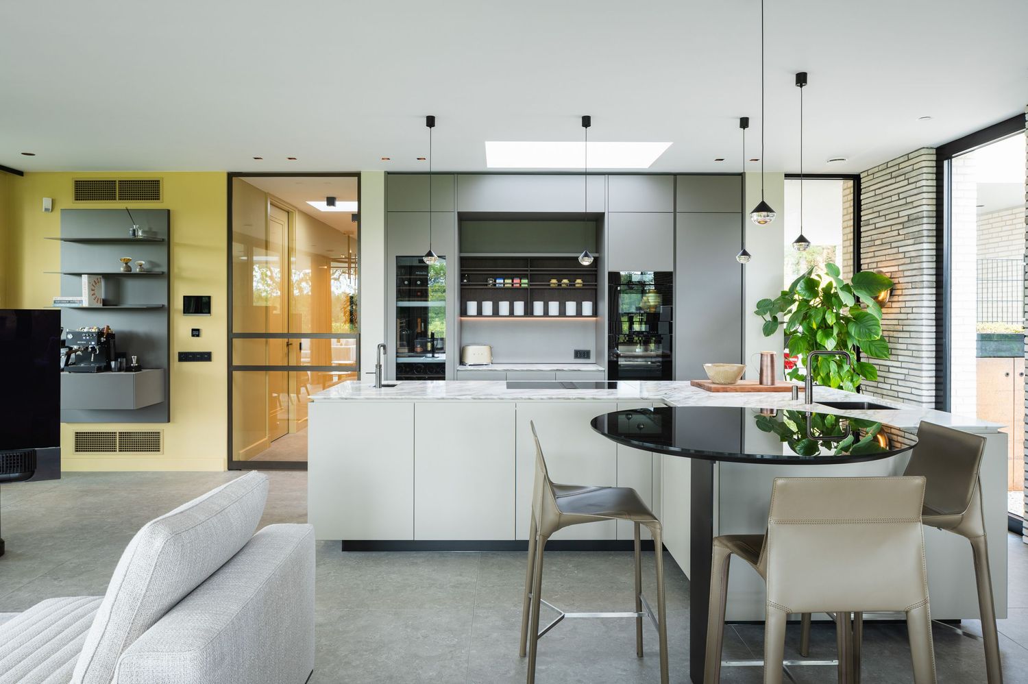 Modern office interior hallway with glass walls, white furniture and minimalist design elements creating a bright workspace.