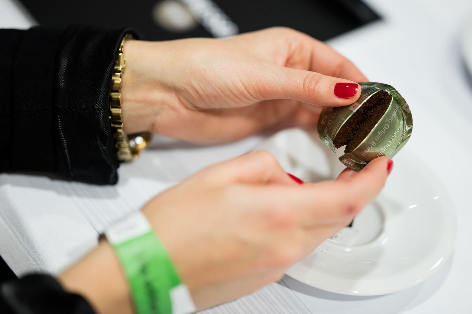 Close-up of hands holding wine glasses during professional tasting.