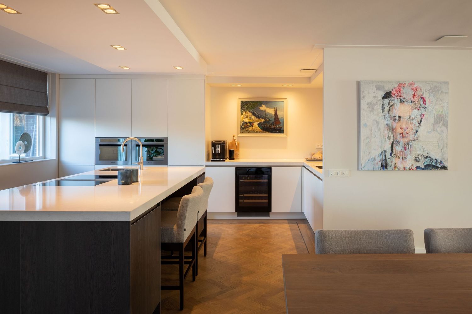 Modern open concept apartment interior with recessed lighting and white walls showcases minimalist design elements.