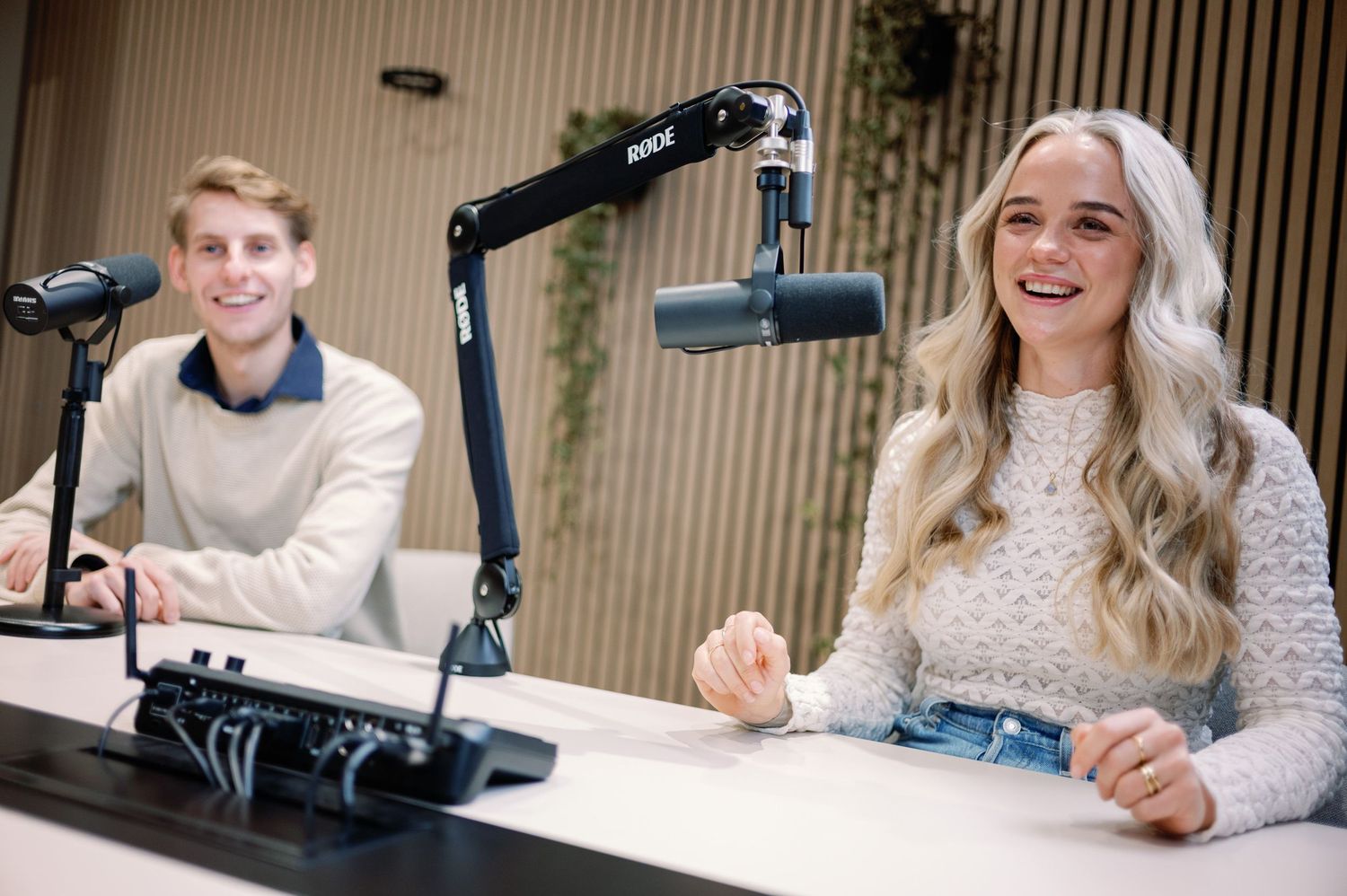 Professional podcast recording setup with microphones and lighting in a modern studio.