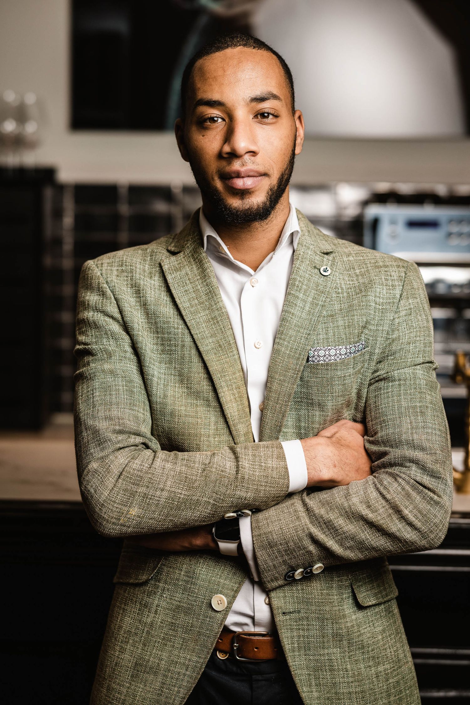 Professional portrait series showing a person in a textured green blazer and white shirt against dark background.