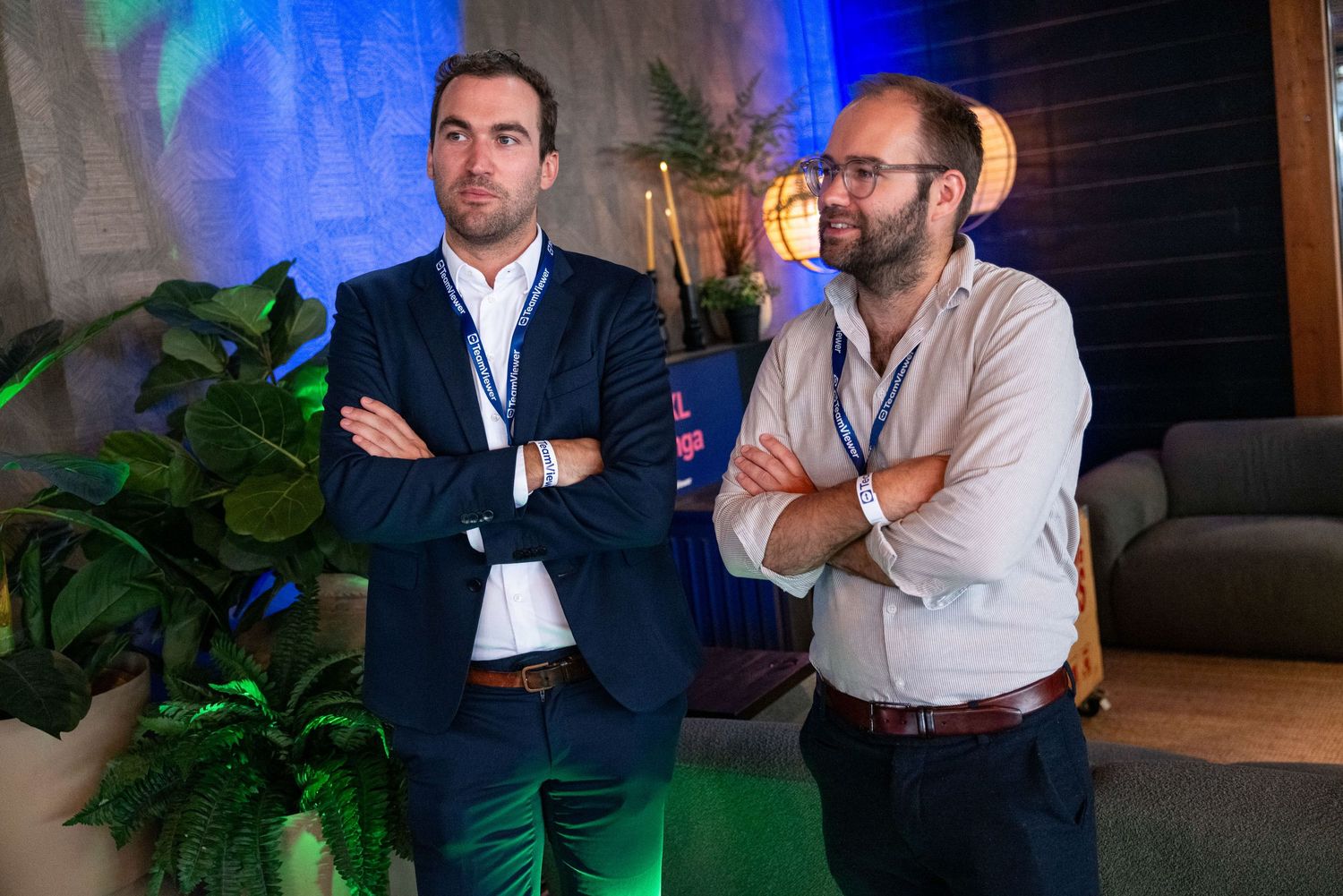 Professional networking event with attendees in business attire against dark background.