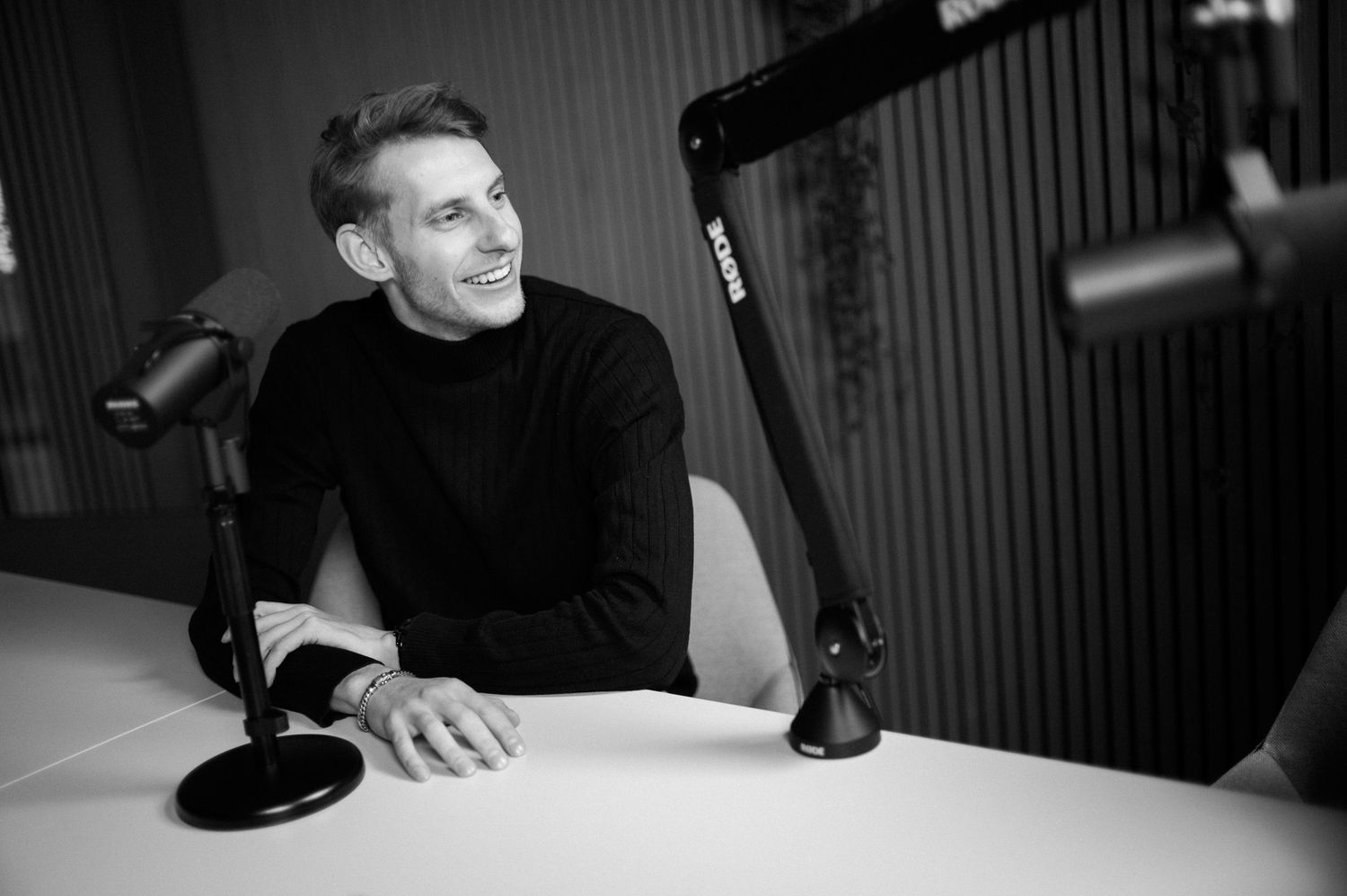 Black and white candid shots of people during a podcast recording session.