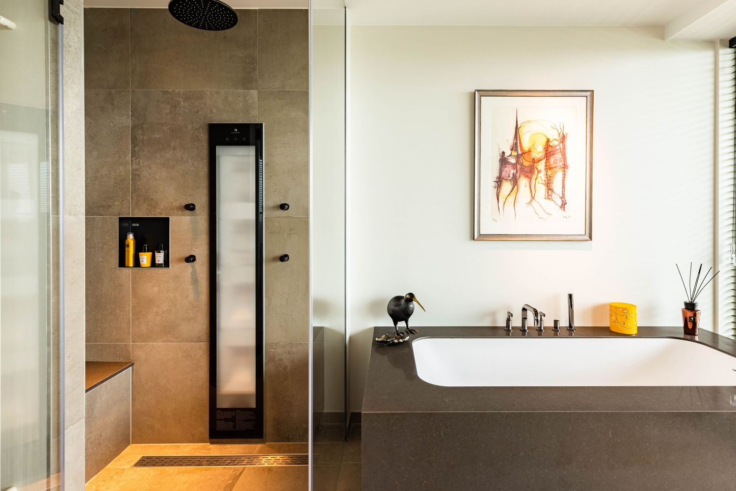 Modern open concept kitchen with concrete walls, pendant lighting, and minimalist design elements.