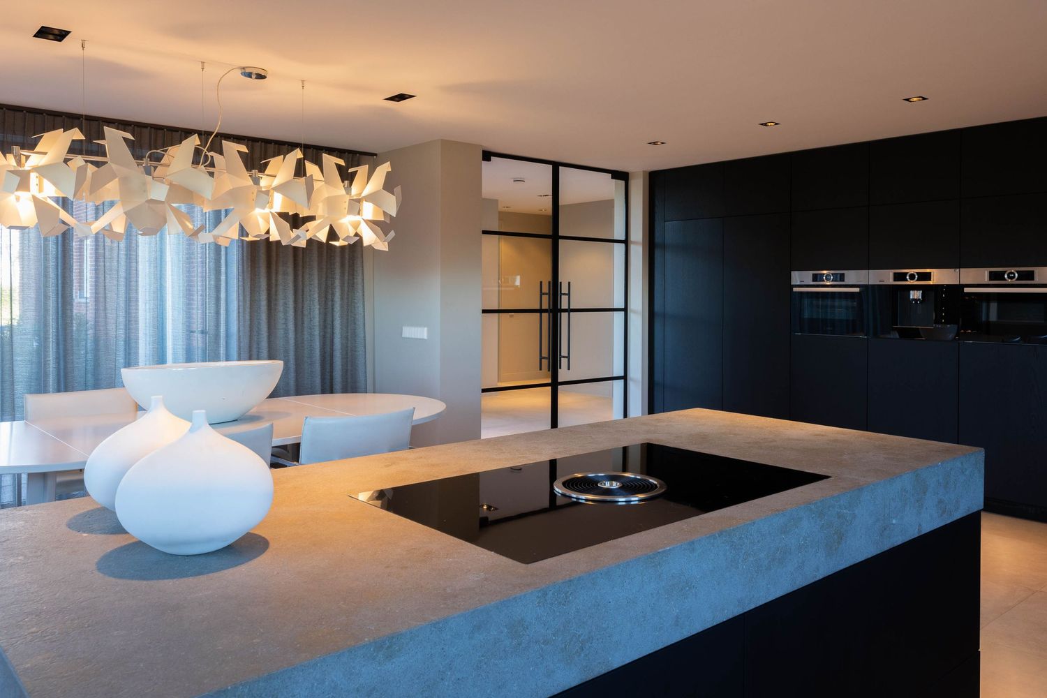 Modern office interior with sleek white furniture, glass partitions, and blue accent lighting creating a futuristic atmosphere.
